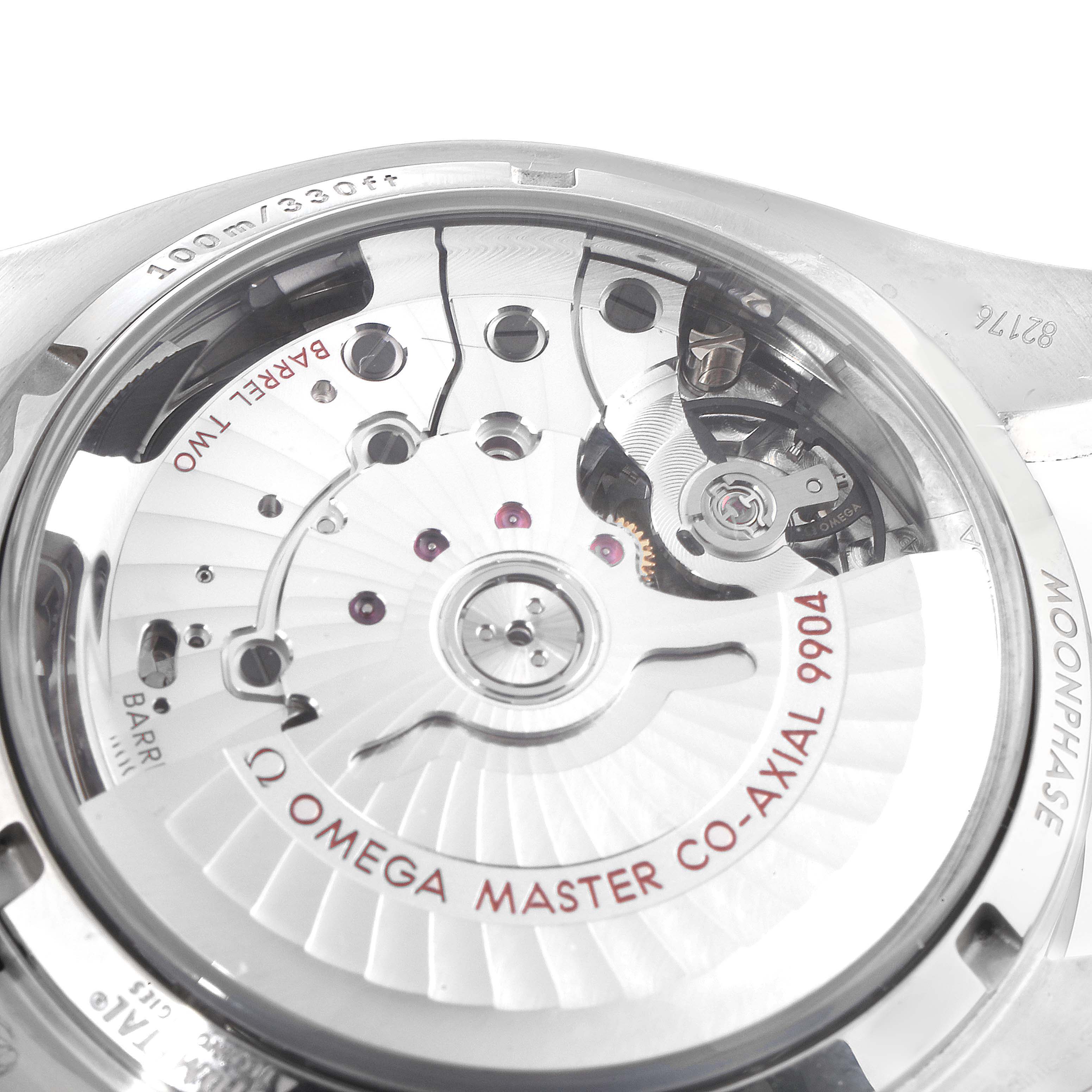 The image shows a close-up of the back of an Omega Speedmaster 304.30.44.52.01.001 Men
s Stainless Steel Black Dial 304.30.44.52.01.001 Men
s Stainless Steel Black Dial watch, highlighting the CO-AXIAL 9904 movement.