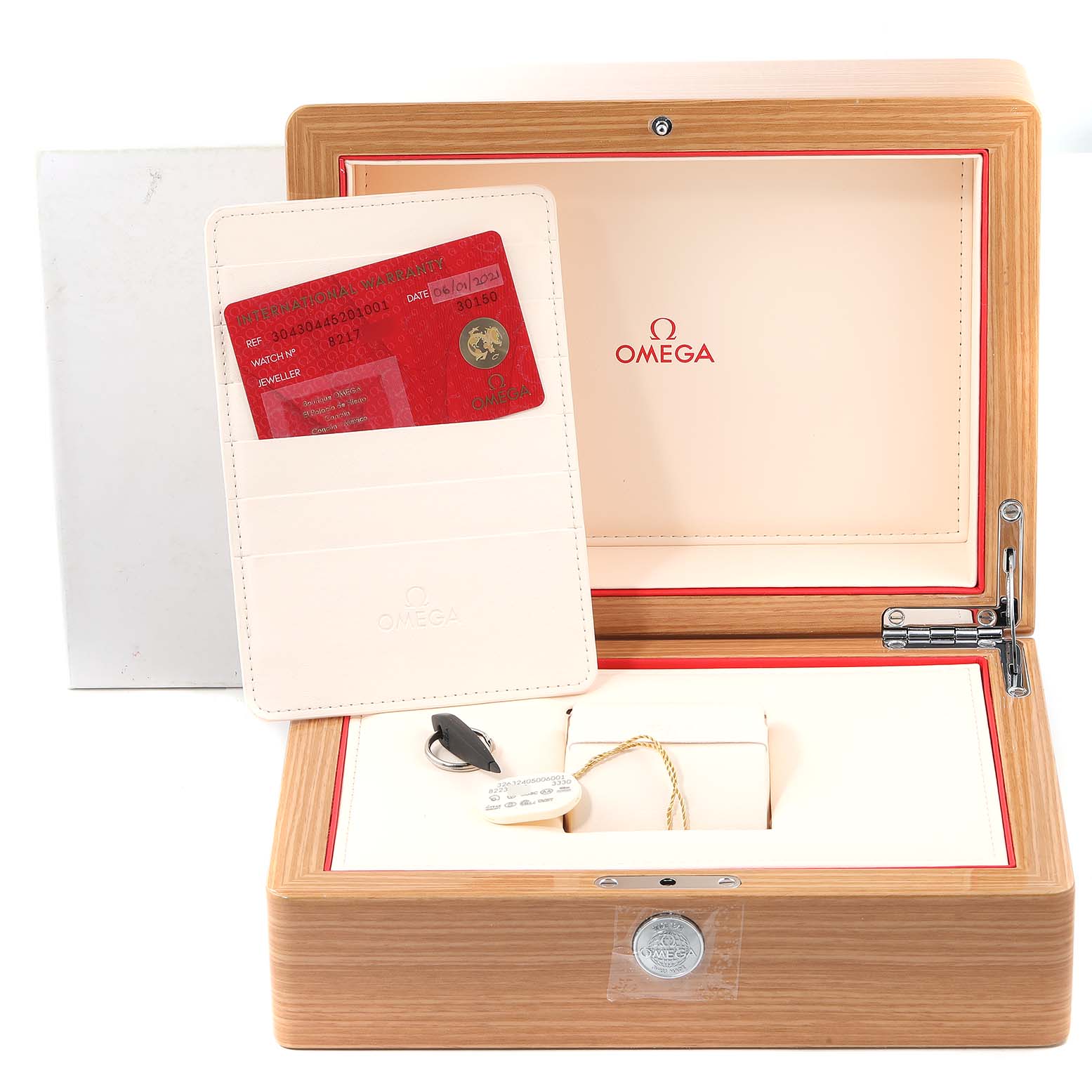 The image shows the open box of an Omega Speedmaster 304.30.44.52.01.001 Men
s Stainless Steel Black Dial 304.30.44.52.01.001 Men
s Stainless Steel Black Dial watch, featuring a warranty card and storage accessories.