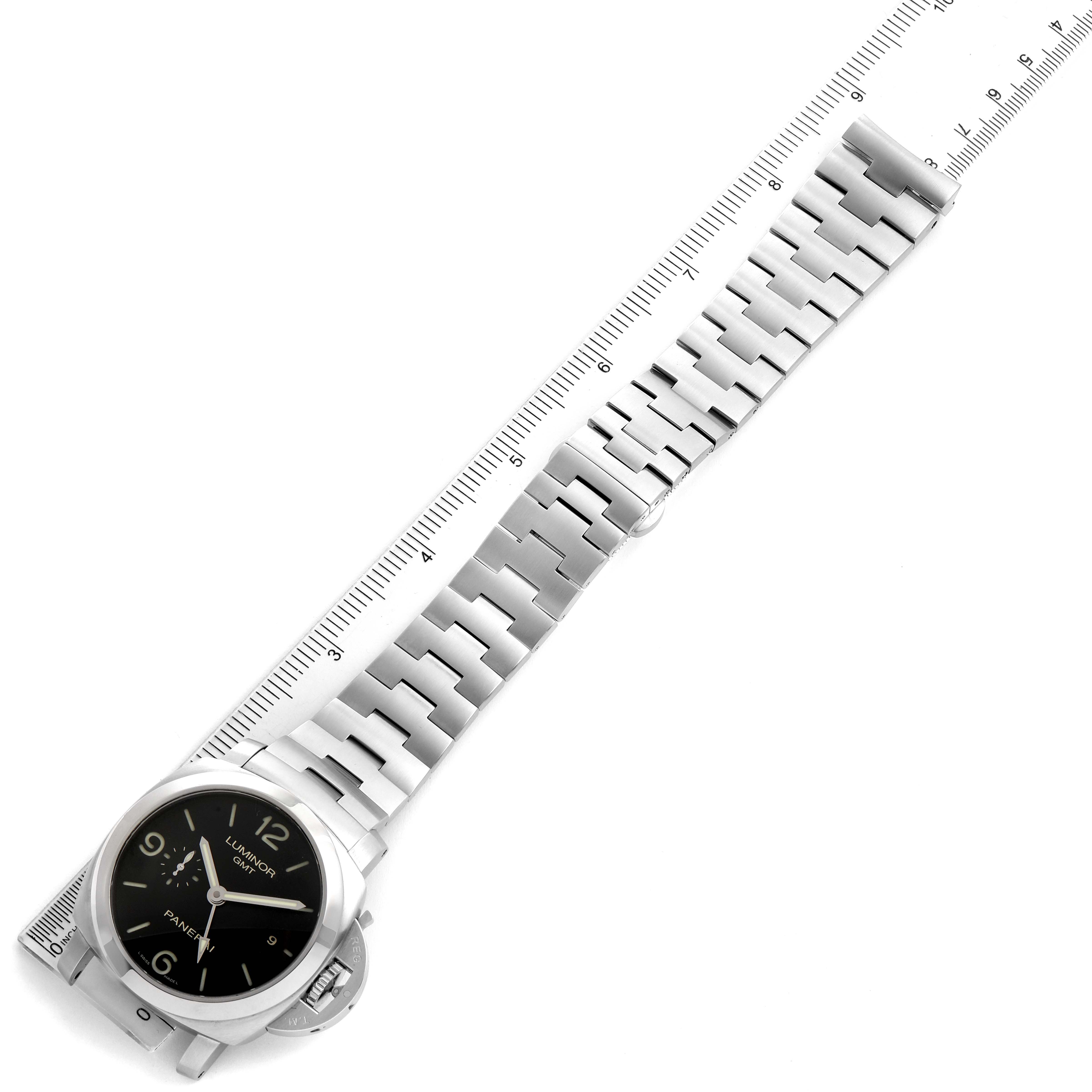 This image shows a Panerai Luminor PAM00329 Men
s Stainless Steel Black Dial PAM00329 Men
s Stainless Steel Black Dial watch laying flat with its metal bracelet extended and aligned next to a ruler for scale.