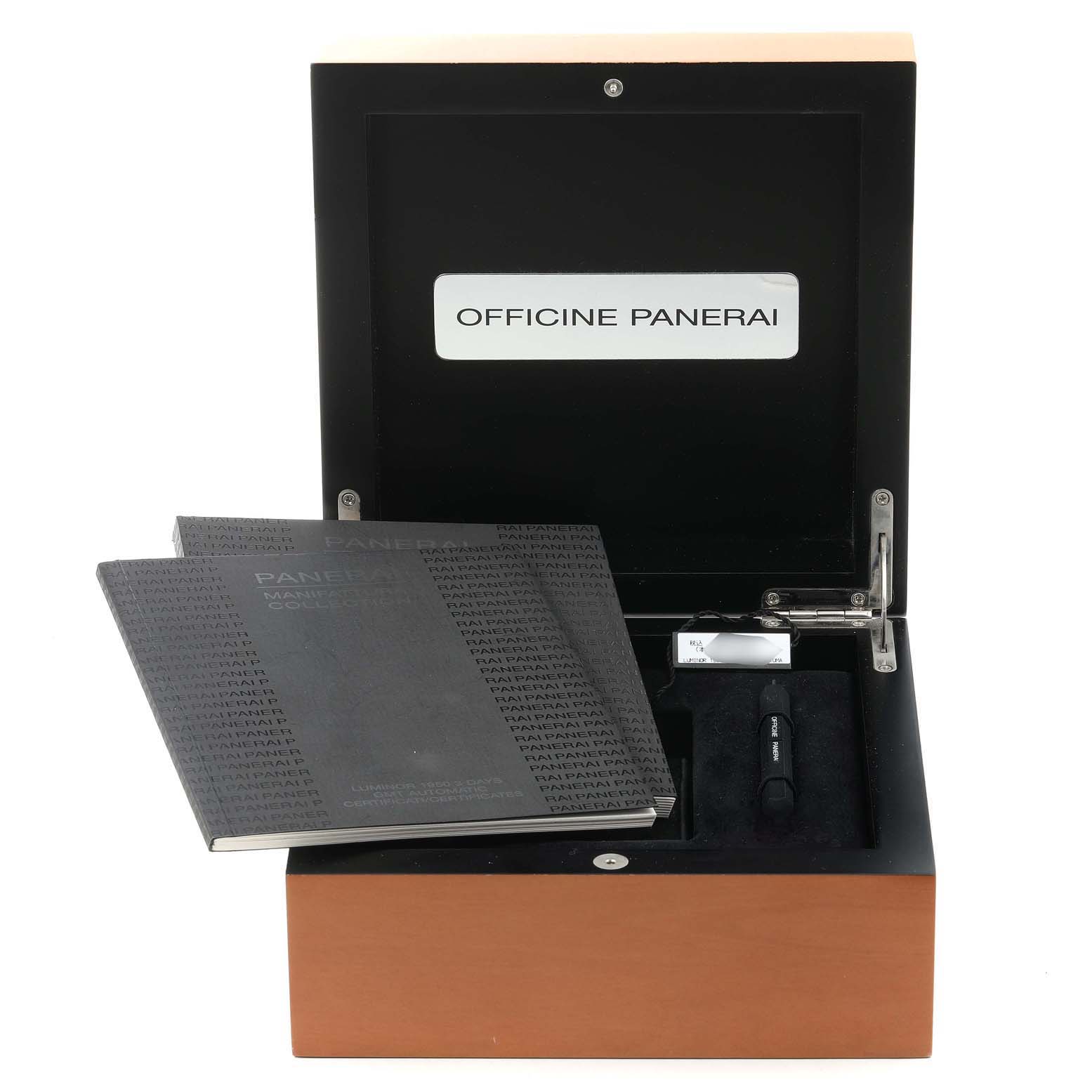 The image shows the accessory box of the Panerai Luminor PAM00329 Men
s Stainless Steel Black Dial PAM00329 Men
s Stainless Steel Black Dial watch, including booklets and a tool, viewed from the front angle.