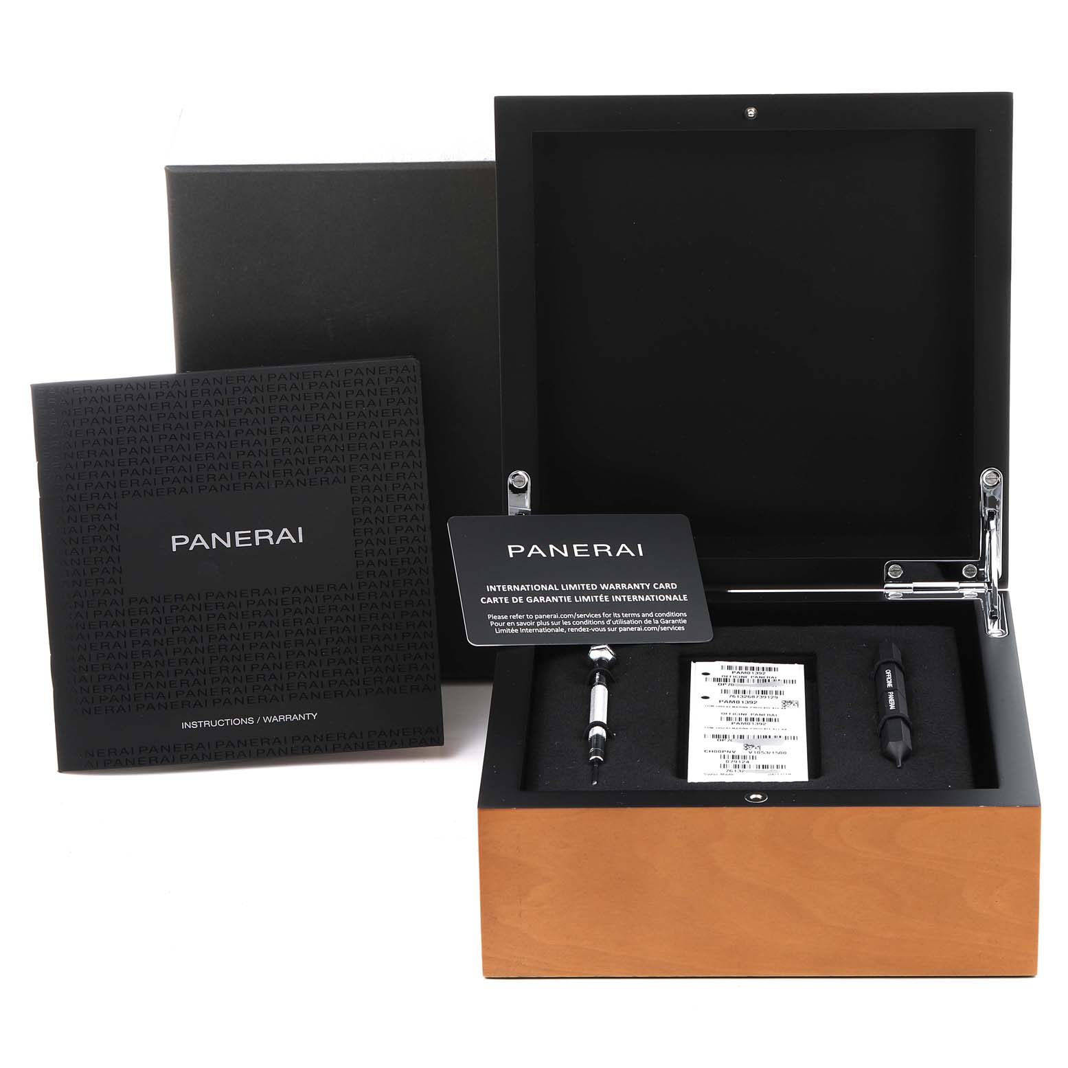 The image shows an open Panerai Luminor PAM01392 Men
s Stainless Steel Black Dial PAM01392 Men
s Stainless Steel Black Dial watch box containing a warranty card, instructions, and tools.