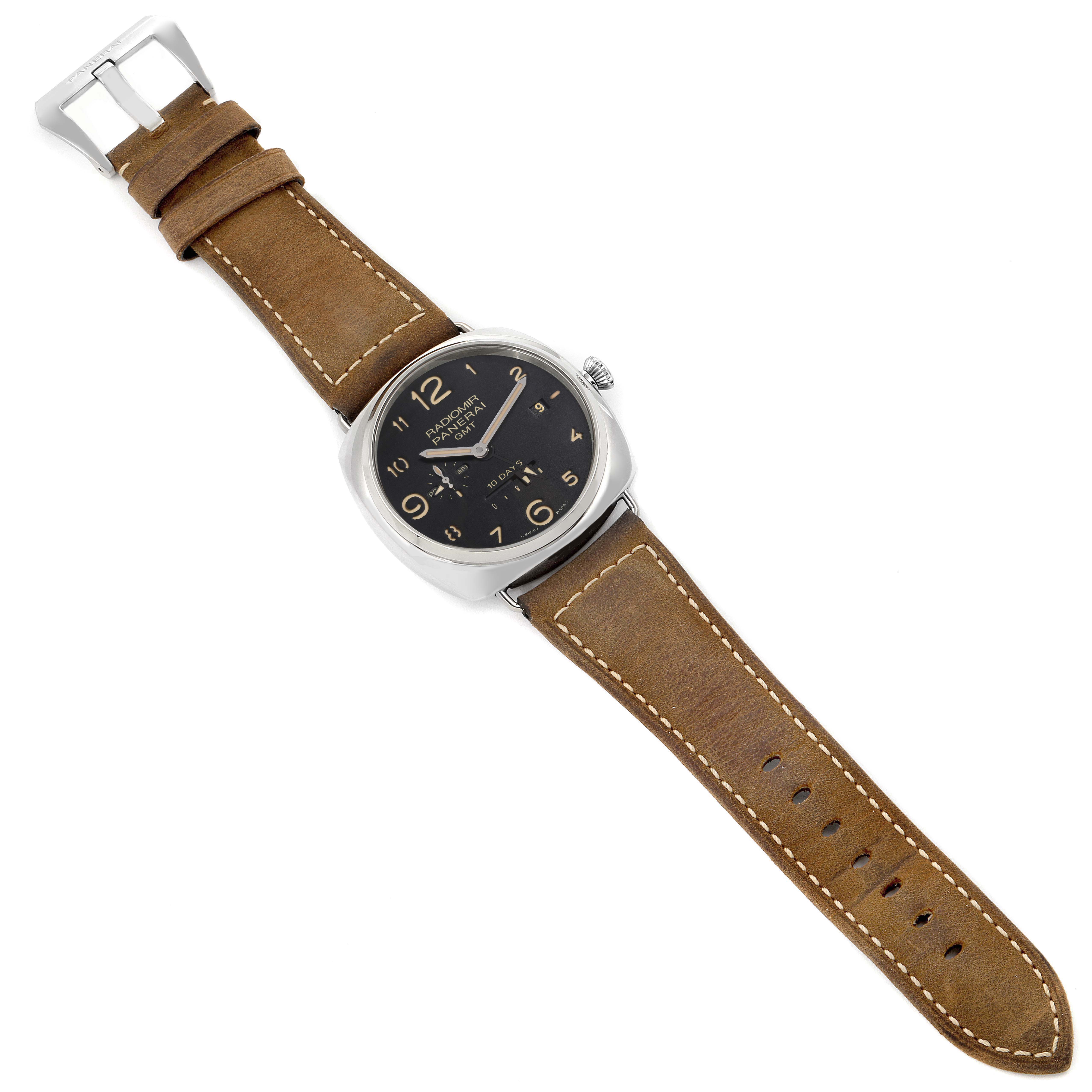 The image shows a Panerai Radiomir PAM00473 men's watch at a slight angle, featuring its brown leather strap, black dial with Arabic numerals, and silver case.