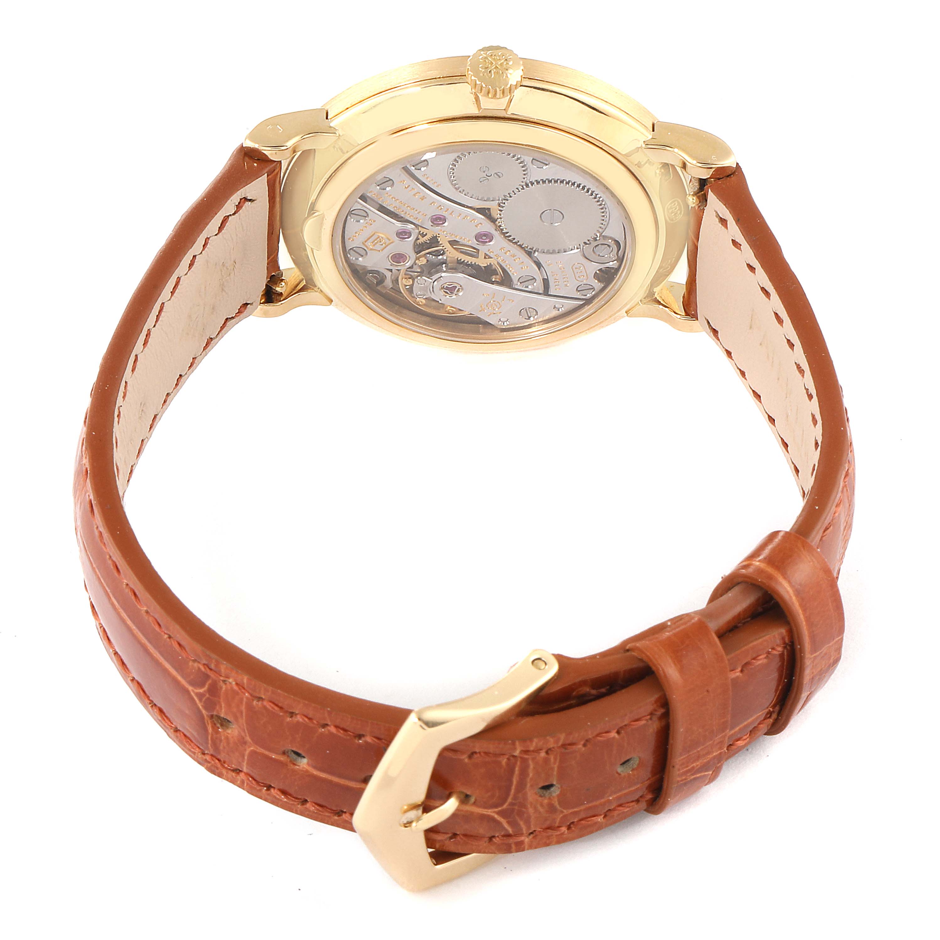 This image shows the back view of a Patek Philippe Calatrava 7119J Men's Yellow Gold White Dial 7119J Men's Yellow Gold White Dial watch, displaying its intricate mechanical movement and brown leather strap.