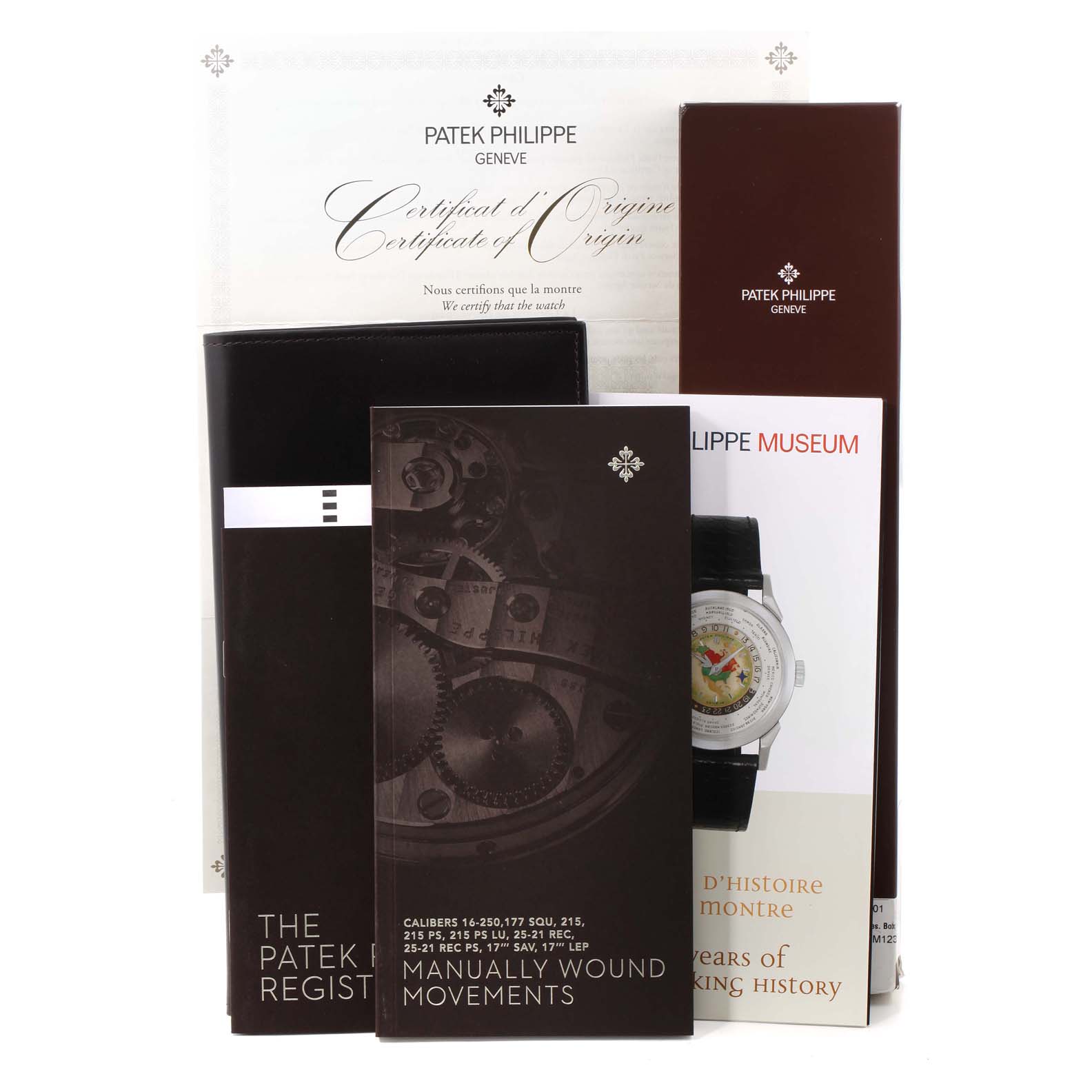 This image shows documentation and booklets for the Calatrava model by Patek Philippe, including a Certificate of Origin and a museum pamphlet.