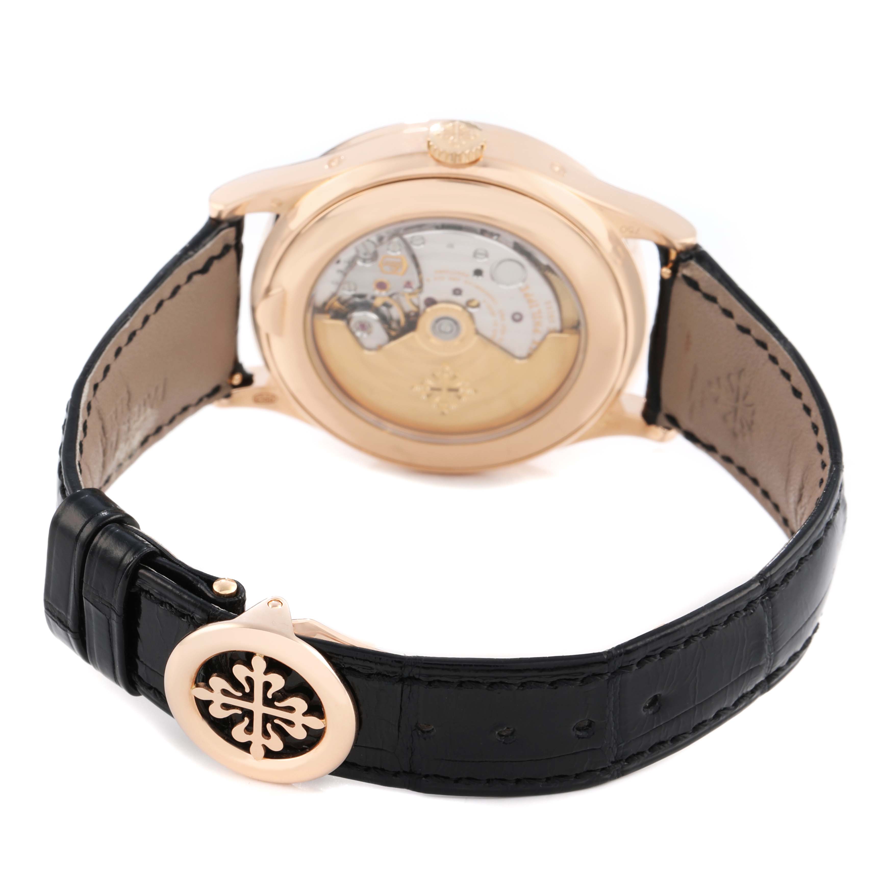 The image shows the back view of the Patek Philippe Complications 5396 Men's Rose Gold Silver Dial watch, highlighting its movement and clasp with logo.