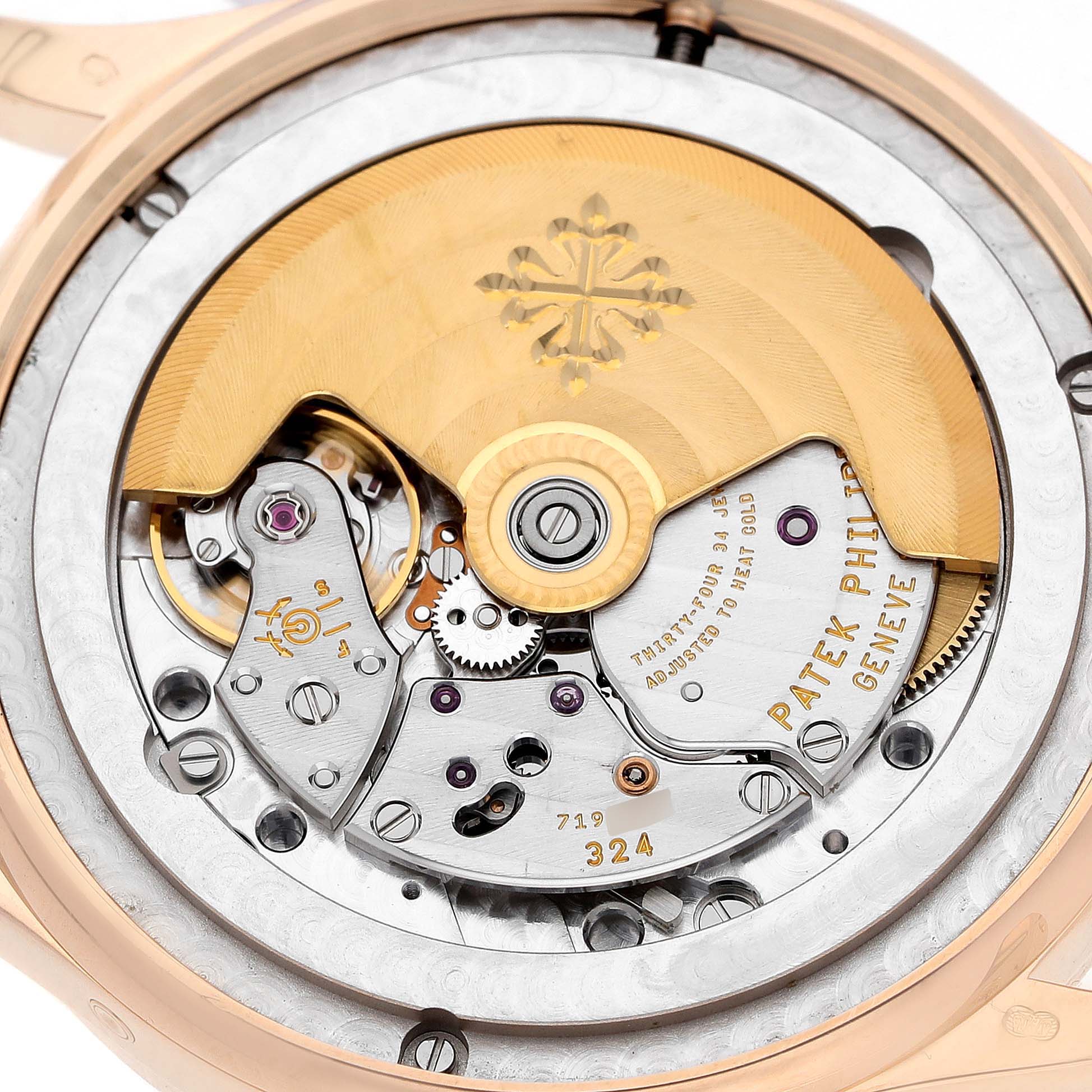 The image shows the back of a Patek Philippe Complications 5396 Men's Rose Gold Silver Dial watch, highlighting its intricate movement and rotor.
