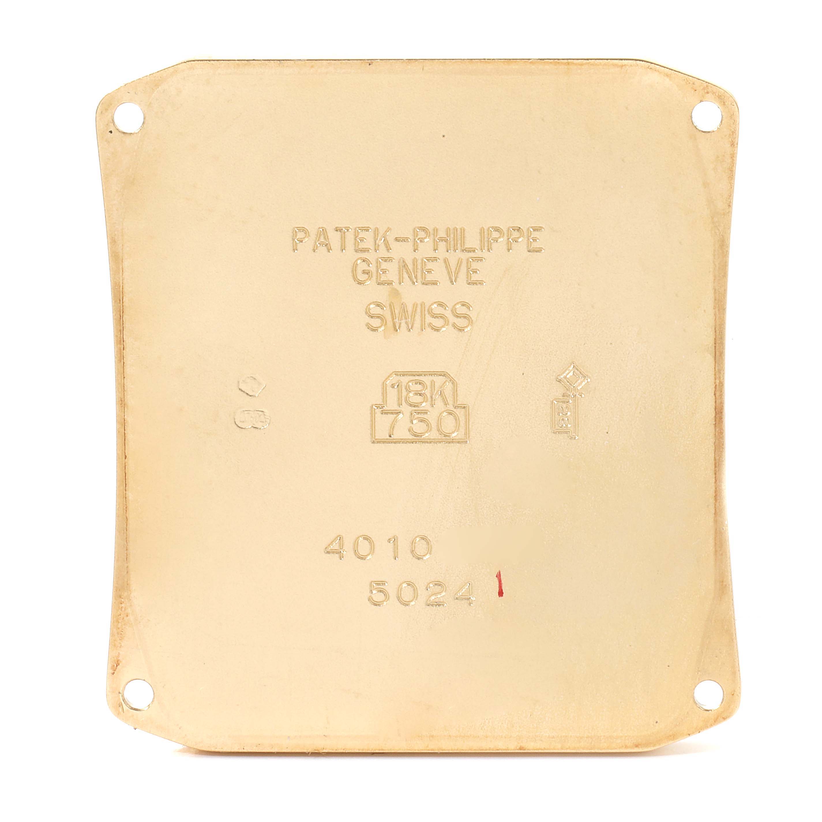 This image shows the back casing of a Patek Philippe Gondolo 5024J Men's Yellow Gold Silver Dial 5024J Men's Yellow Gold Silver Dial watch, displaying its engravings and hallmarks.