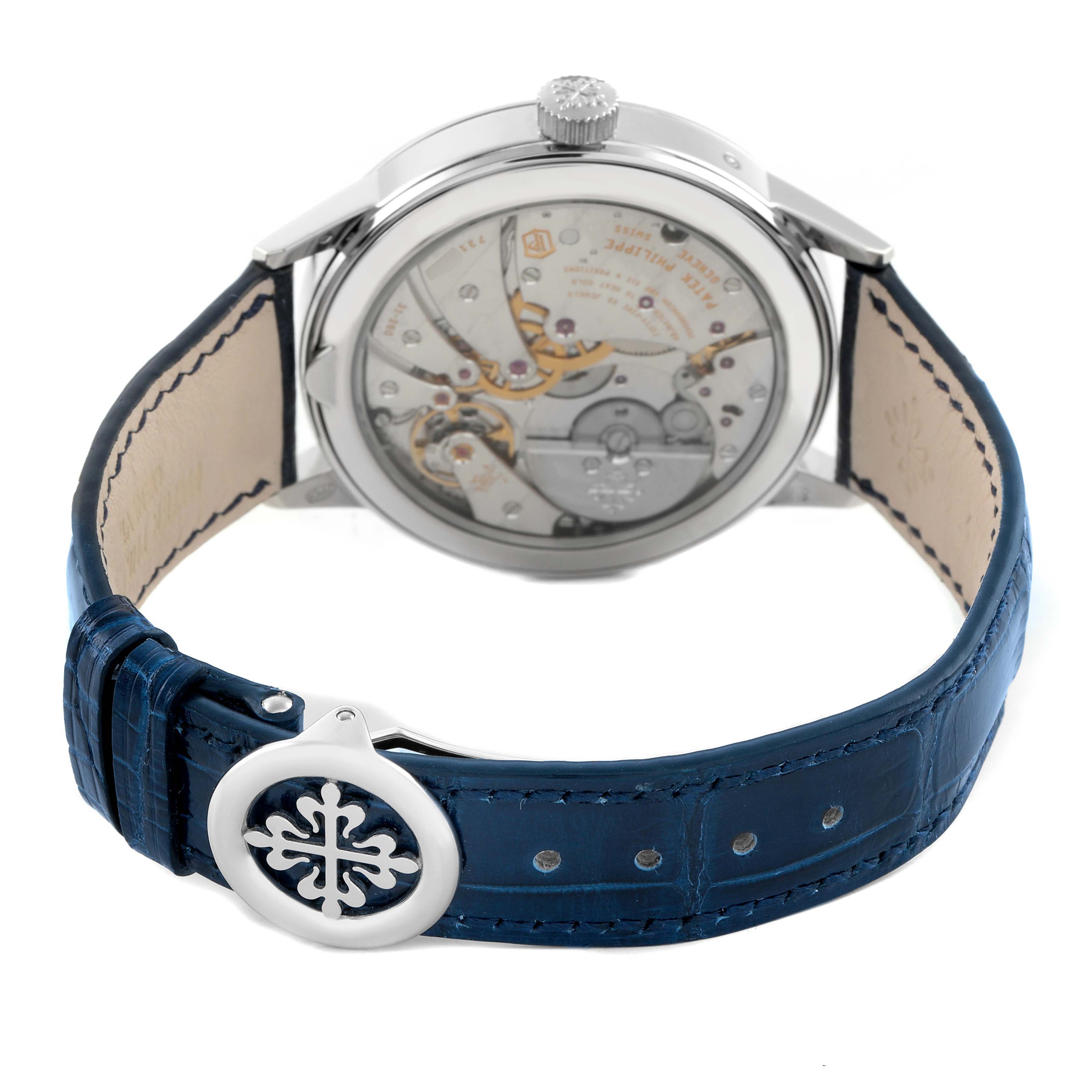 The image shows a rear view of the Patek Philippe Complications 5236 Men's Platinum Blue Dial watch, highlighting its open case back and blue leather strap.