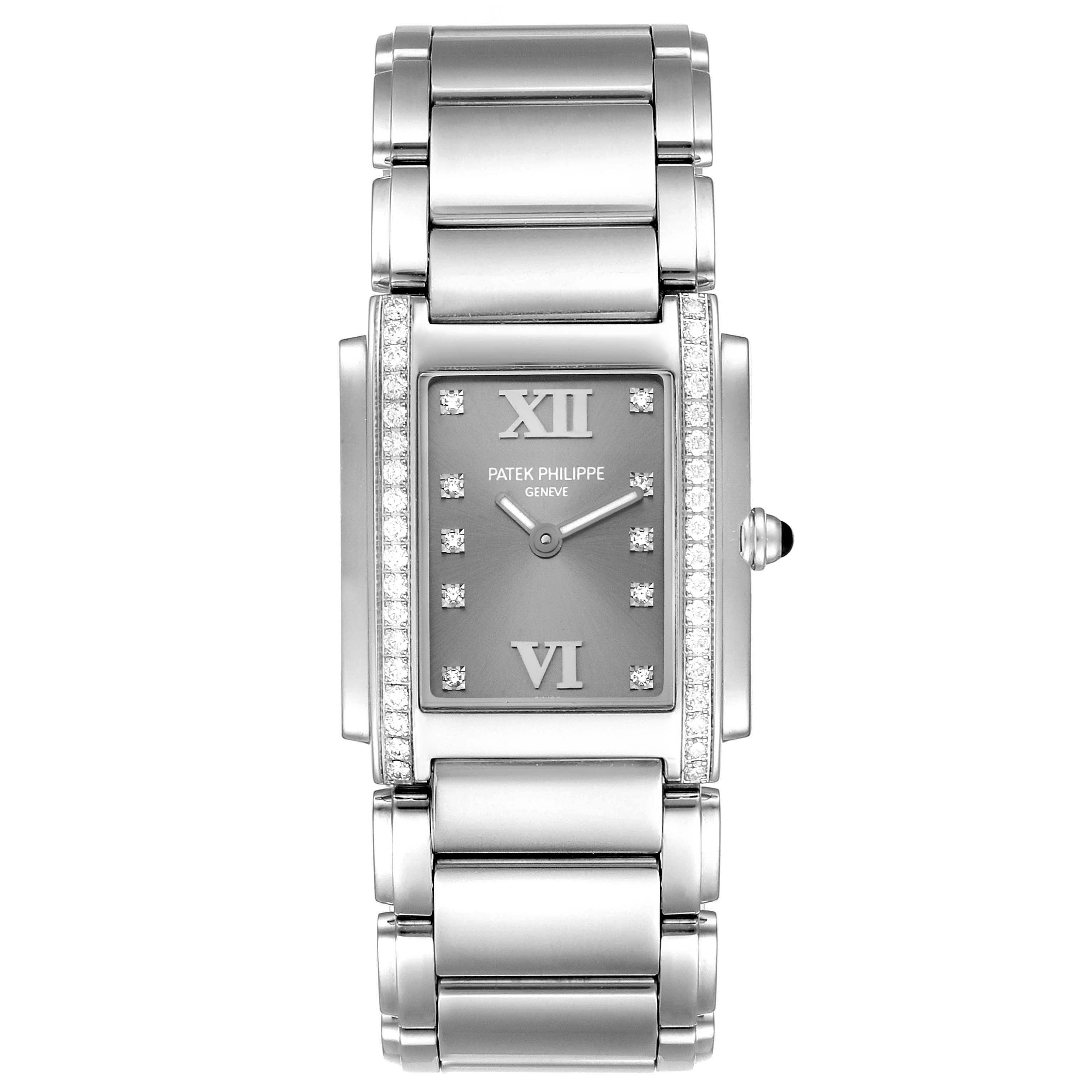 The image displays a front view of the Patek Philippe Twenty-4 4910/10A-010 Women's Stainless Steel Grey Dial 4910/10A-010 Women's Stainless Steel Grey Dial watch, showcasing its rectangular face, bracelet, and side crown.