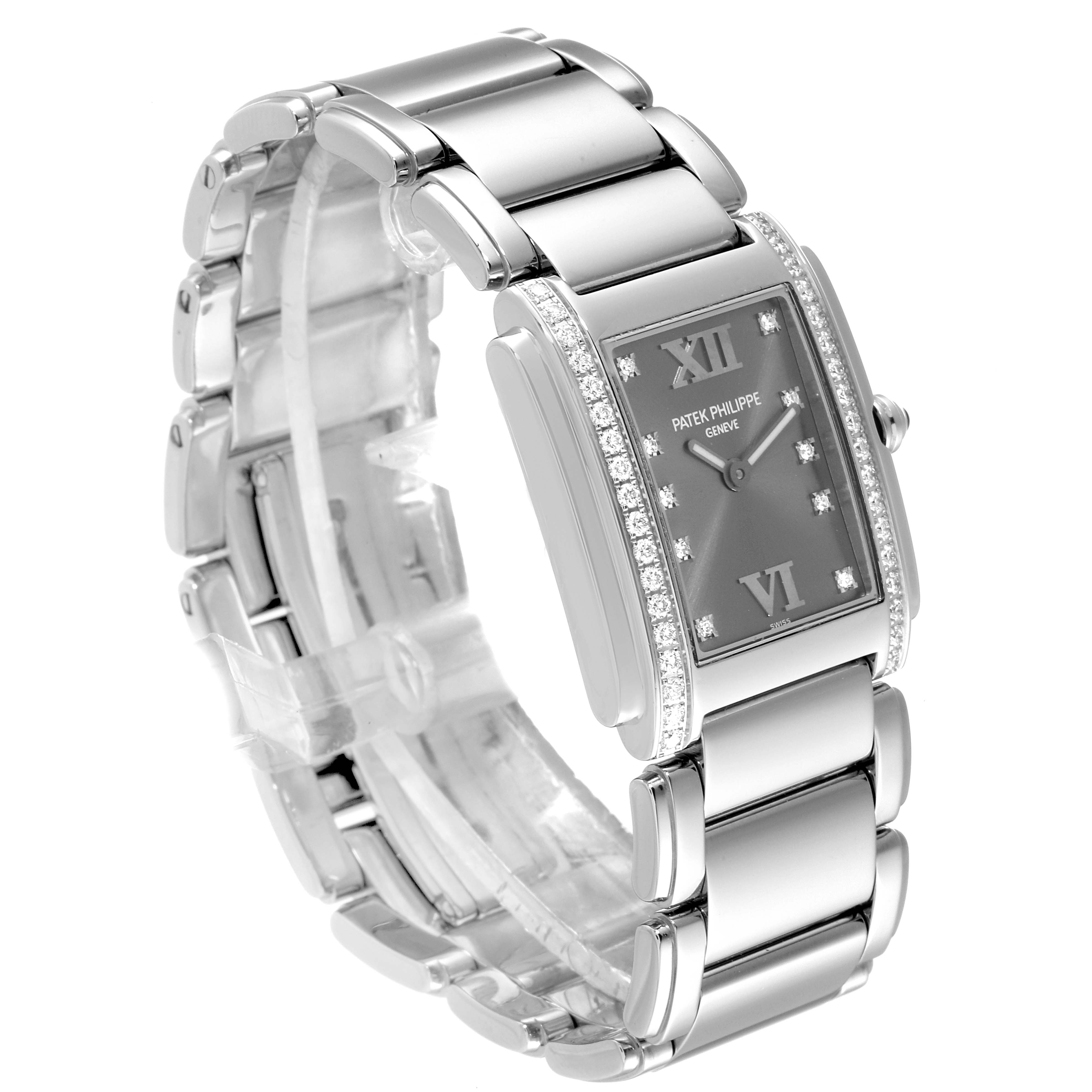 The image shows a Patek Philippe Twenty-4 4910/10A-010 Women's Stainless Steel Grey Dial 4910/10A-010 Women's Stainless Steel Grey Dial watch from a three-quarter view, highlighting its face, bezel, and bracelet.