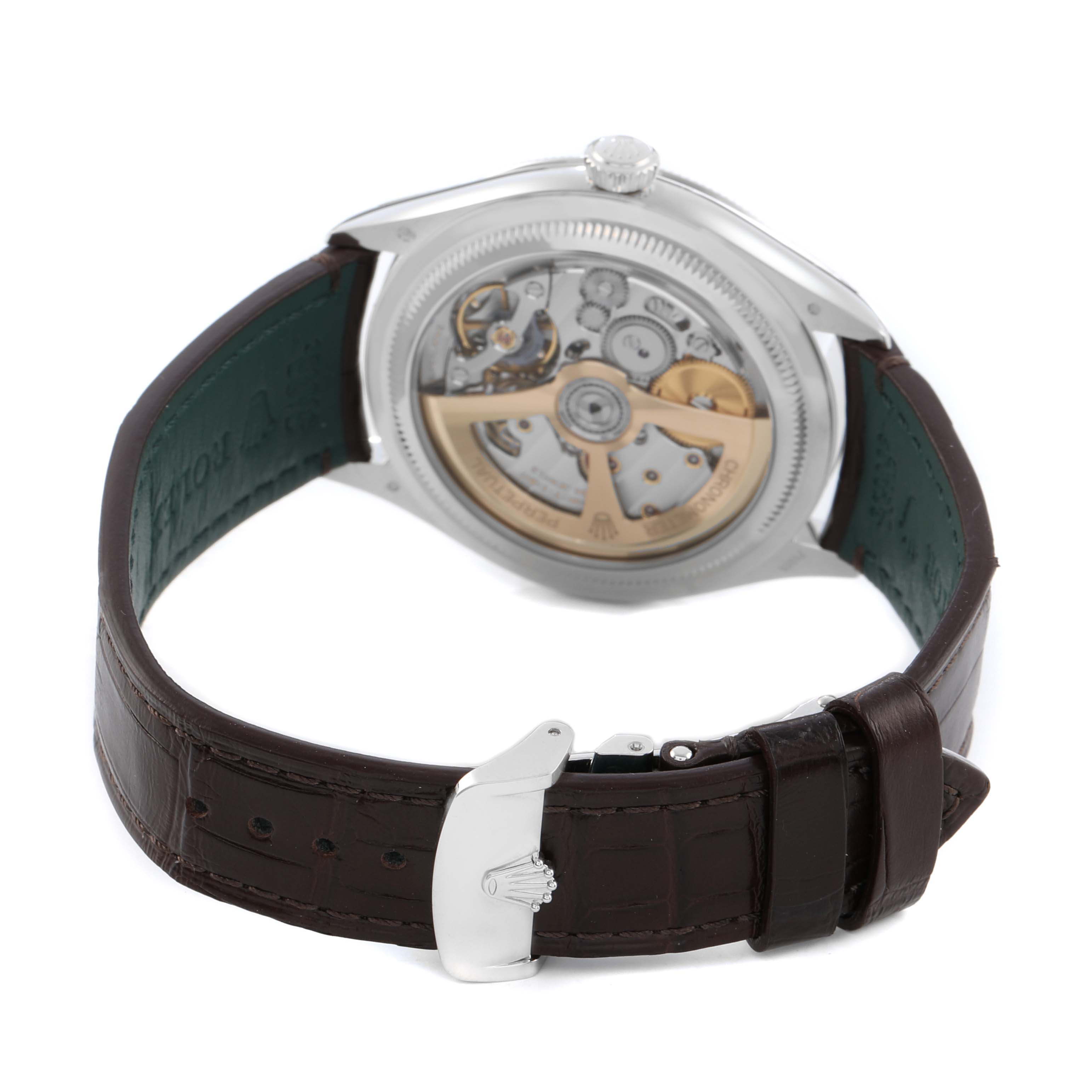 The Rolex 1908 52506 Men's Platinum Blue Dial model is shown from the back, highlighting its transparent case back and visible movement with a brown leather strap.