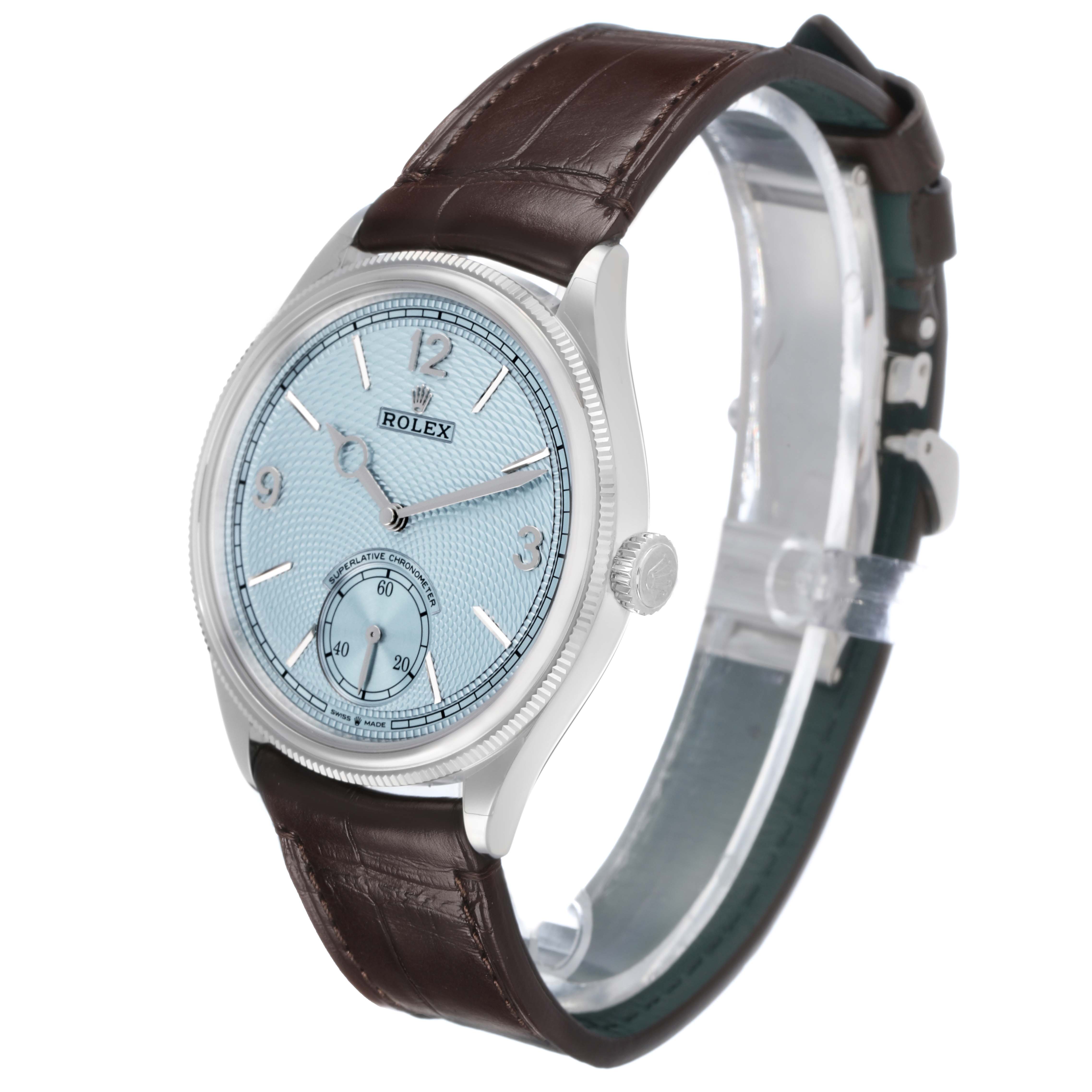 The Rolex 1908 52506 Men's Platinum Blue Dial model is shown at a three-quarter angle, highlighting its face, crown, and brown leather strap.
