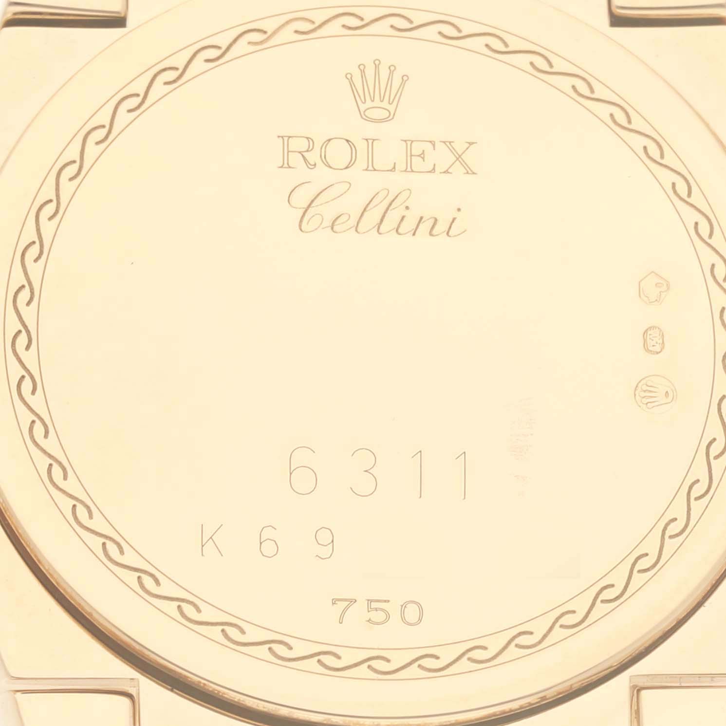 The image shows the back of a Rolex Cellini 6311 Women's Yellow Gold Mother of Pearl Dial 6311 Women's Yellow Gold Mother of Pearl Dial watch, highlighting engravings and hallmarks.