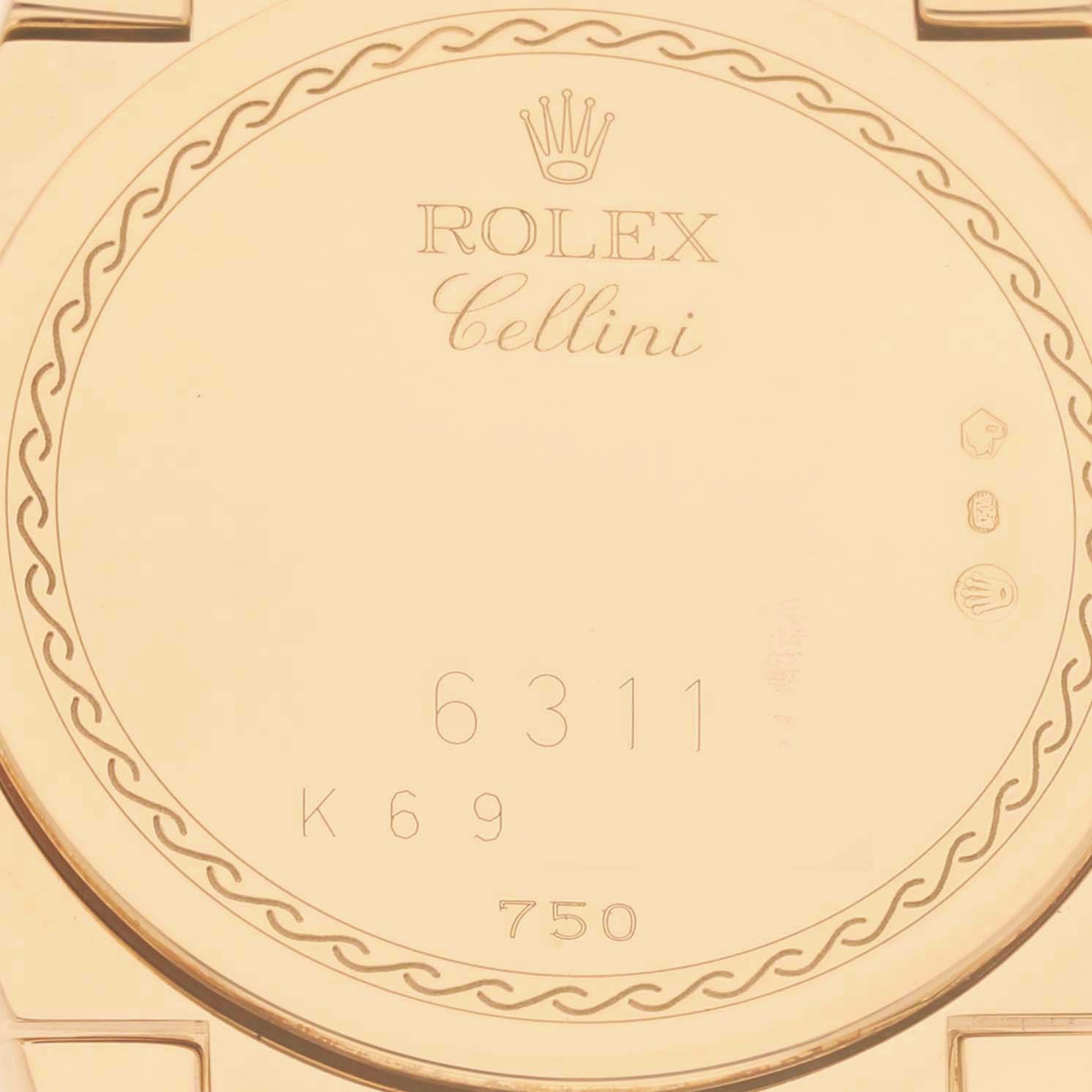 The image shows the back case of a Rolex Cellini 6311 Women's Yellow Gold Mother of Pearl Dial watch, featuring brand engravings and serial numbers.