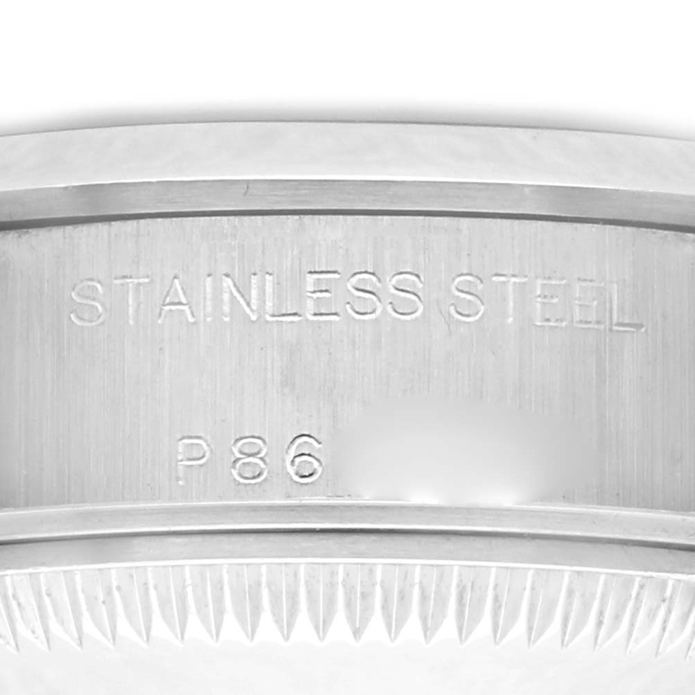 The image shows a close-up of the case back of a Rolex Date 79160 Women
s Stainless Steel Blue Dial 79160 Women
s Stainless Steel Blue Dial watch, highlighting the stainless steel material and serial engraving.