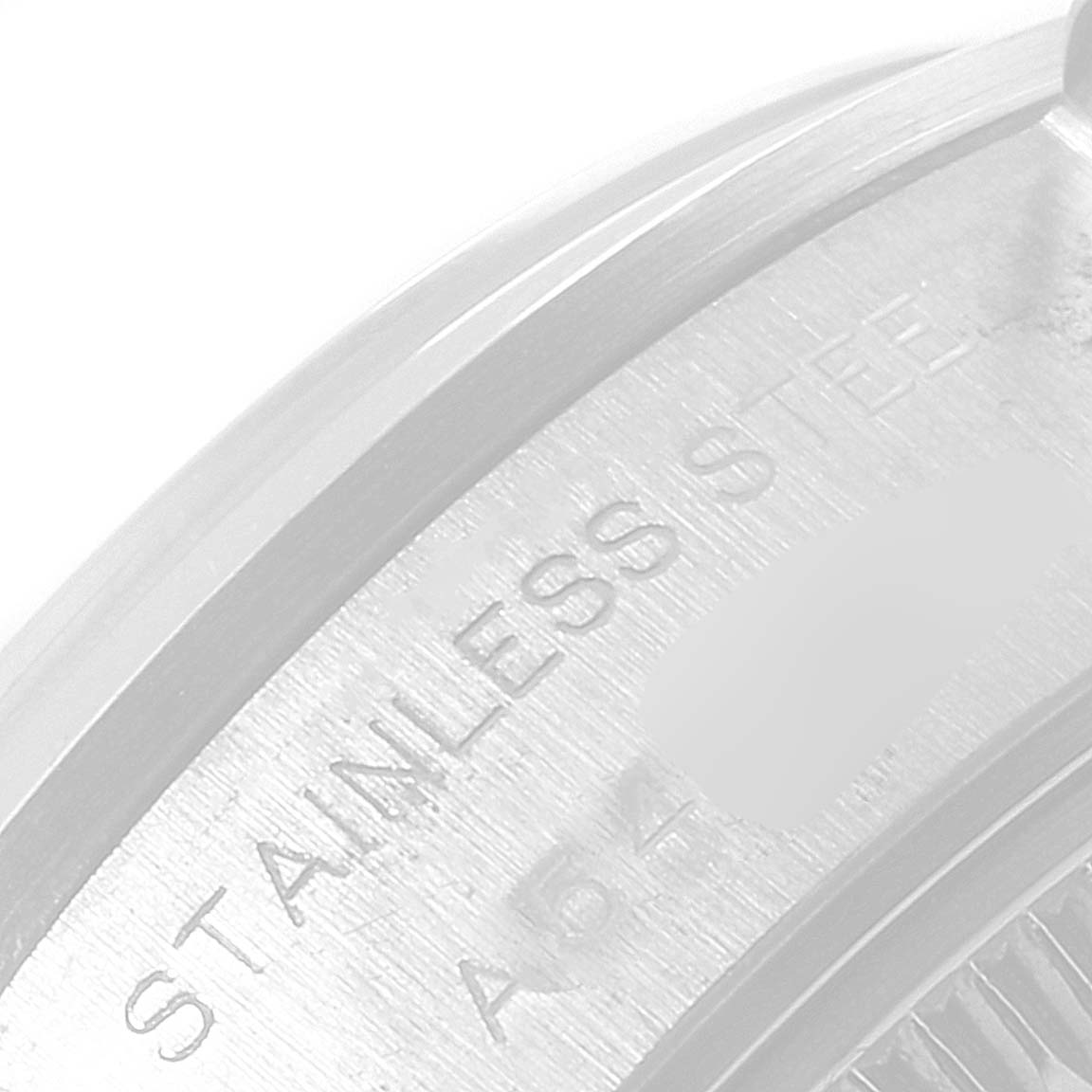 This is a close-up image showing part of the case back of a Rolex Date 79160 Women's Stainless Steel Black Dial 79160 Women's Stainless Steel Black Dial model watch, with "STAINLESS STEEL" engraved on it.