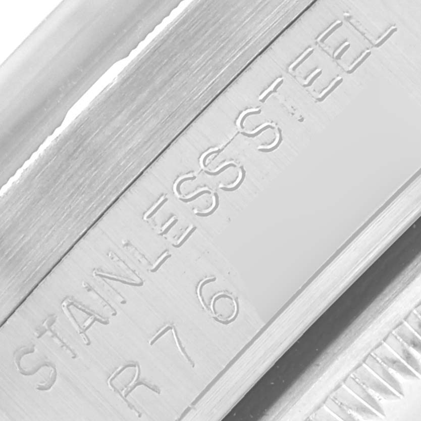 The image shows a close-up of the inner case with engraving details of the Rolex Date 15010 Men's Stainless Steel Silver Dial 15010 Men's Stainless Steel Silver Dial model, highlighting the "STAINLESS STEEL" text.