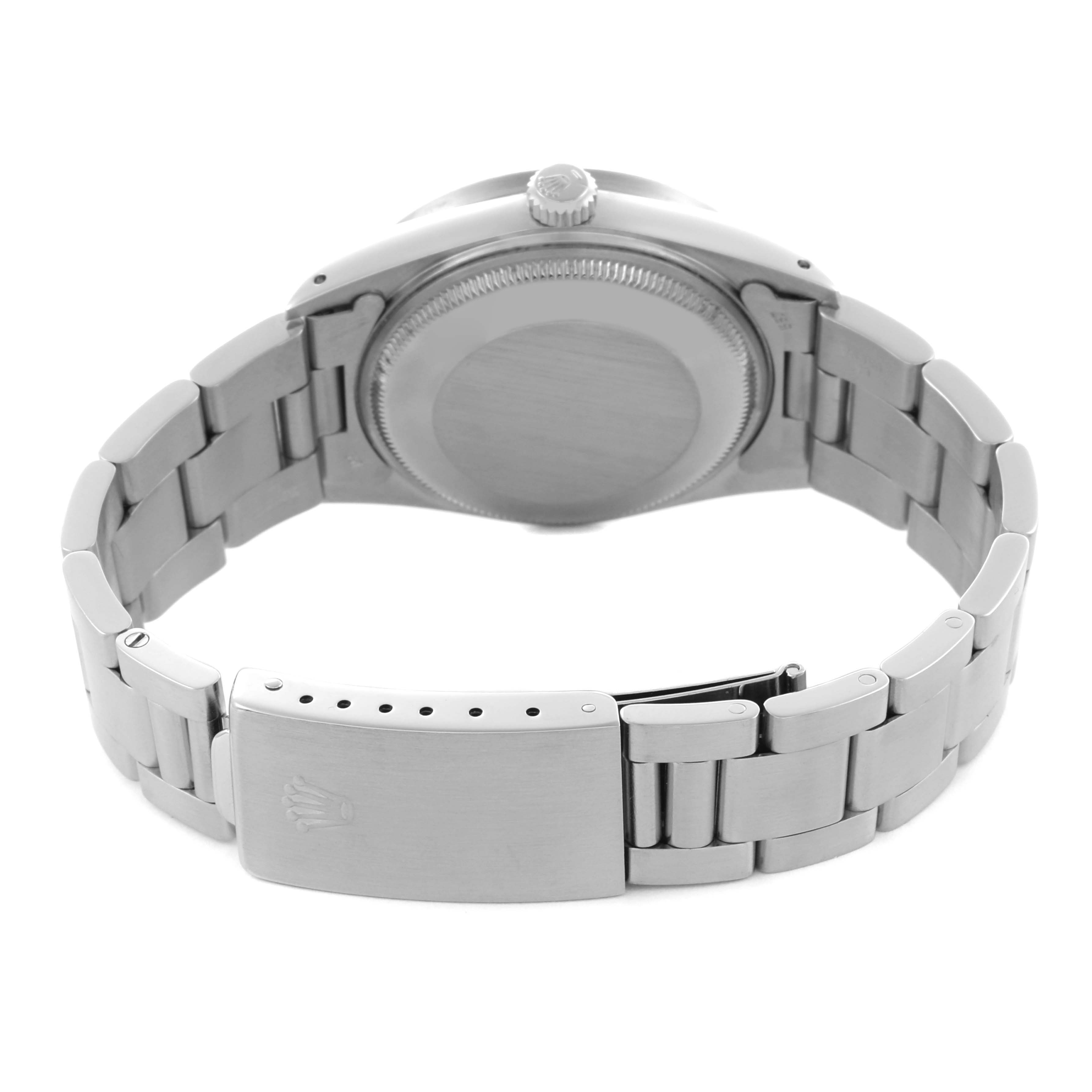 The image shows the back view of a Rolex Date 15010 Men's Stainless Steel Silver Dial 15010 Men's Stainless Steel Silver Dial watch, highlighting the stainless steel case, bracelet, and clasp.