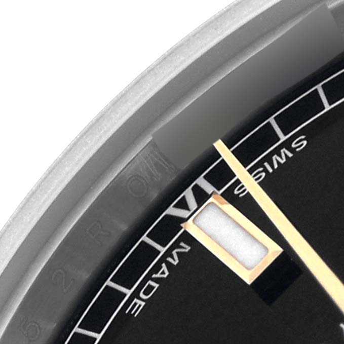 The image shows a close-up of the dial and hands of a Rolex Mid-Size 178243 Women's Steel and Gold (two tone) Black Dial 178243 Women's Steel and Gold (two tone) Black Dial watch at an angle focusing on the "Swiss Made" detail.