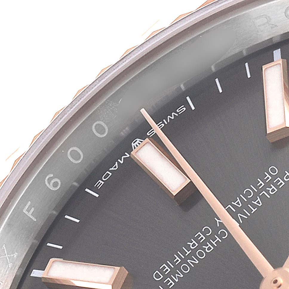The image shows a close-up of the dial and part of the bezel of a Rolex Datejust 126231 Men
s Steel and Gold (two tone) Grey Dial 126231 Men
s Steel and Gold (two tone) Grey Dial watch.