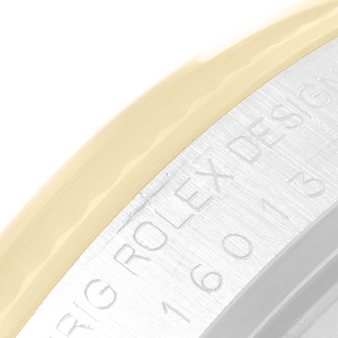 This image shows a close-up of the engraved bezel and part of the dial ring of a Rolex Datejust 16013 Men's Steel and Gold (two tone) Champagne Dial 16013 Men's Steel and Gold (two tone) Champagne Dial watch.