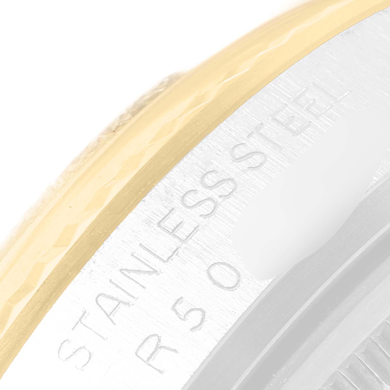 The image shows a close-up angle of the Rolex Datejust 16013 Men's Steel and Gold (two tone) Champagne Dial 16013 Men's Steel and Gold (two tone) Champagne Dial watch's side, highlighting the stainless steel inscription and part of the bezel.