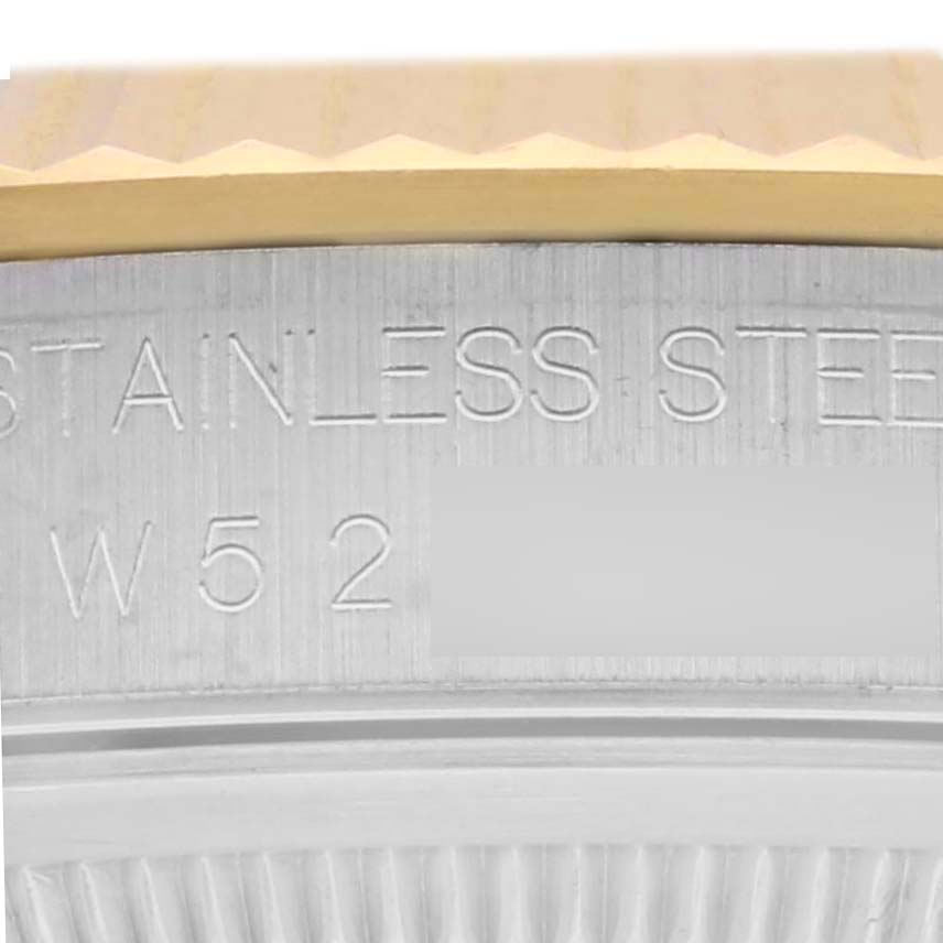 The image shows the side view of a Rolex Datejust 16233 Men's Steel and Gold (two tone) Champagne Dial 16233 Men's Steel and Gold (two tone) Champagne Dial's fluted bezel and engraved stainless steel details.