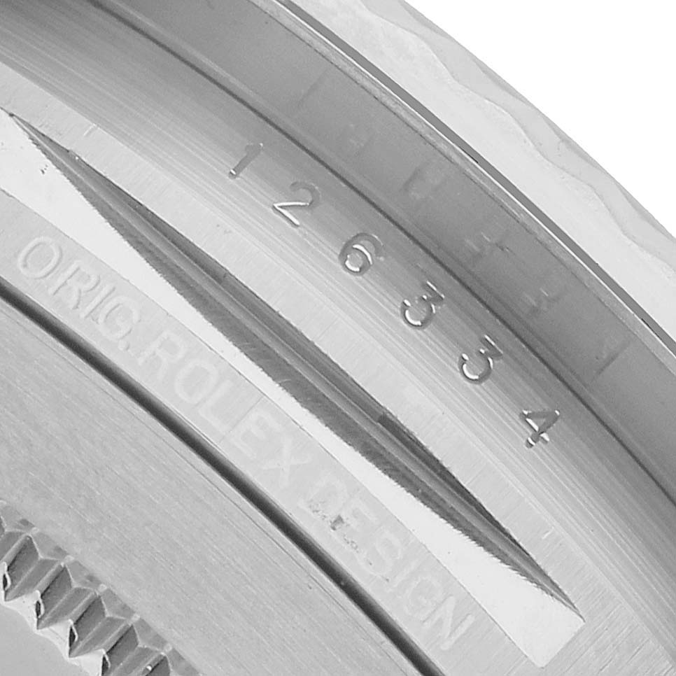 The image shows a close-up of the case side of a Rolex Datejust 41 126334 Men's Stainless Steel Grey Dial, highlighting the model number and "ORIG. ROLEX DESIGN" engraving.