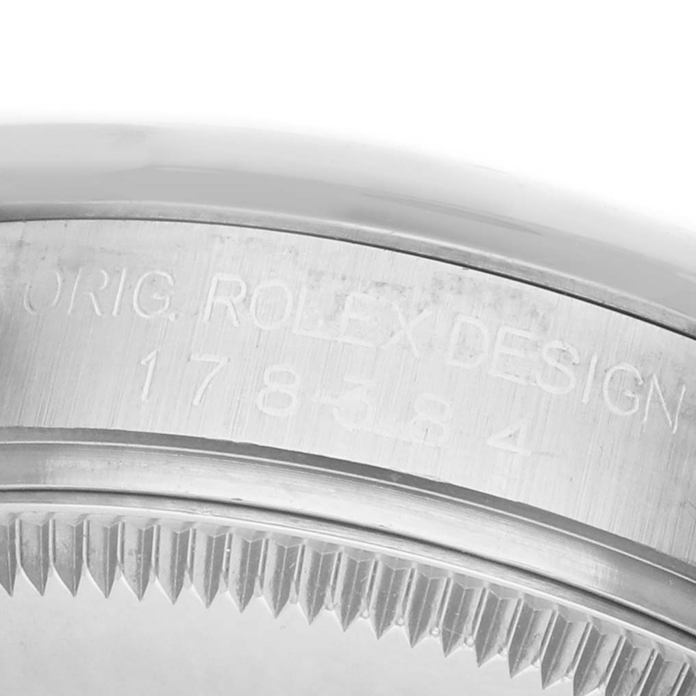 This image shows a close-up of the case side and bezel edge of a Rolex Datejust 178384 Women's Stainless Steel Mother of Pearl Dial, featuring engraved text.