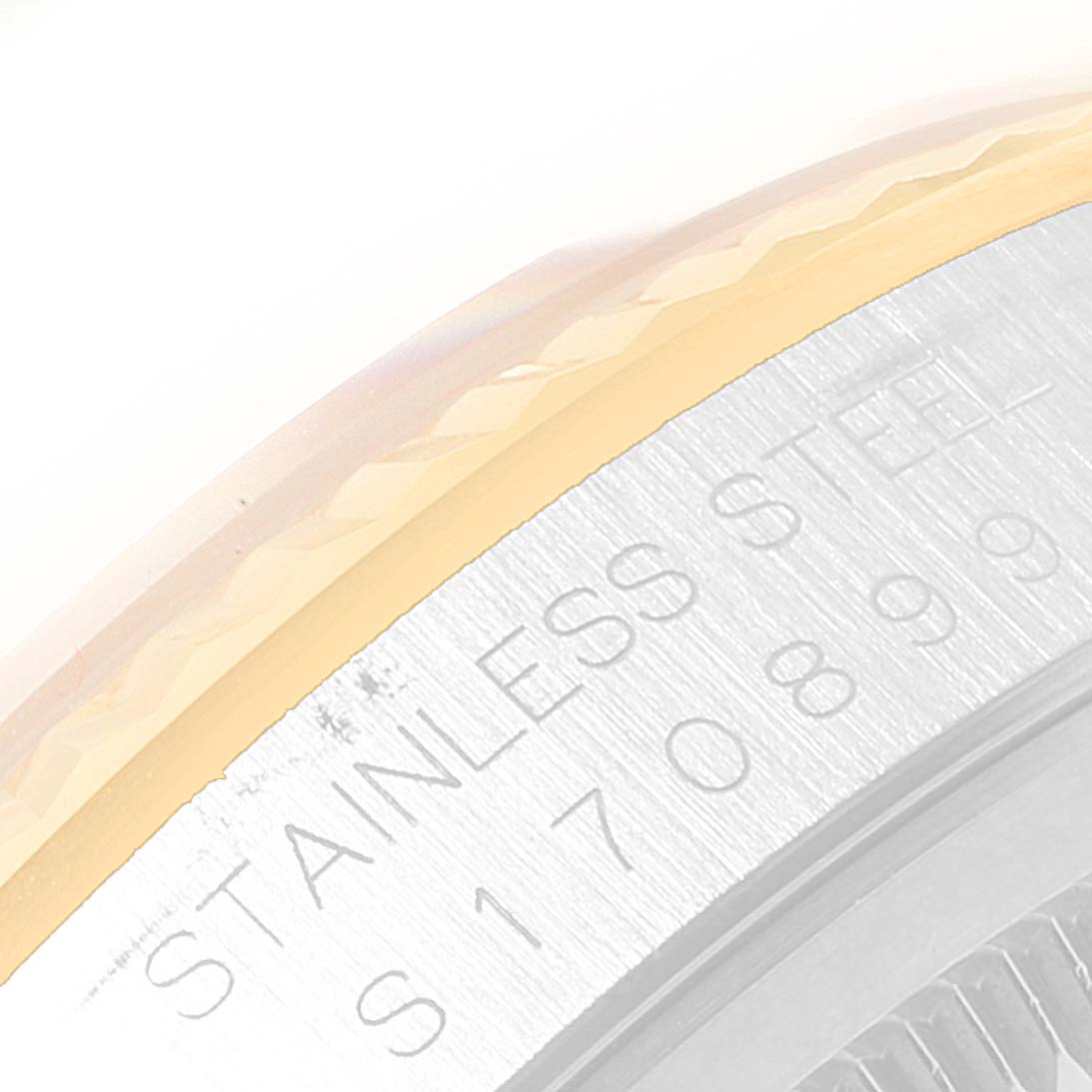 This image shows a close-up of the side edge of a Rolex Datejust 16233 Men
s Steel and Gold (two tone) Champagne Dial 16233 Men
s Steel and Gold (two tone) Champagne Dial watch, focusing on the stainless steel and part of the bezel.