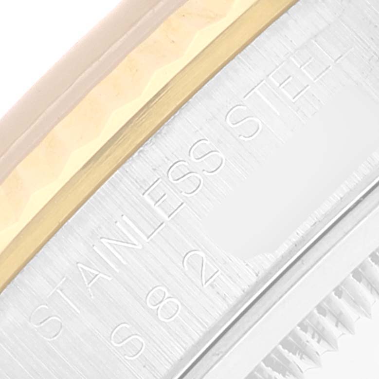 This image shows a close-up of the bezel and part of the case back with the "Stainless Steel" engraving on a Rolex Datejust 16233 Men's Steel and Gold (two tone) Grey Dial 16233 Men's Steel and Gold (two tone) Grey Dial model.