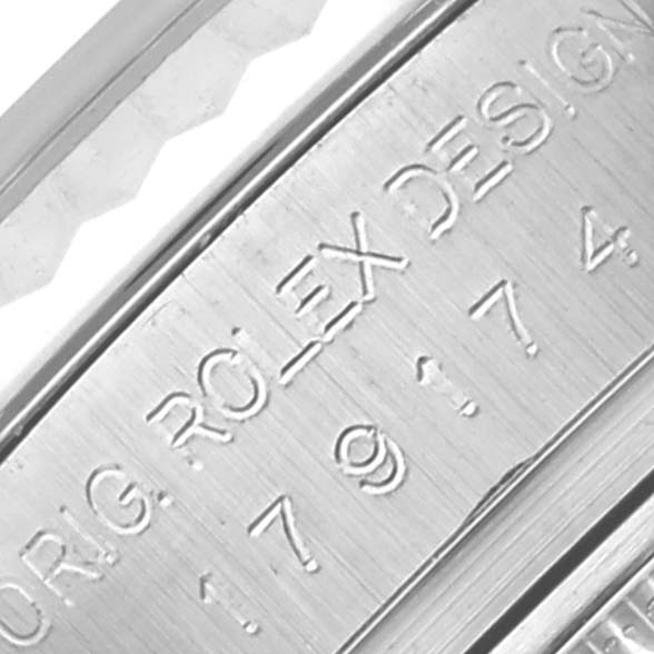 The image shows a close-up of the engraved side of the case of a Rolex Datejust 179174 Women's Stainless Steel Black Dial 179174 Women's Stainless Steel Black Dial watch.