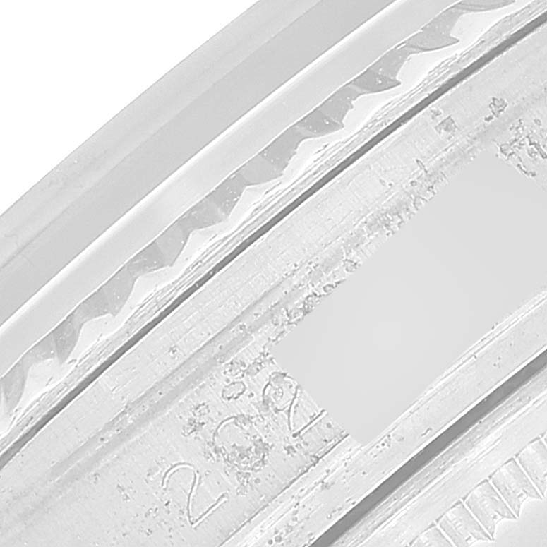 This is a close-up image showing the engraved inner bezel of a Datejust model by Rolex.