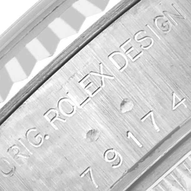 The image shows an engraved inner rim of a Rolex Datejust 79174 Women's Stainless Steel Pink Dial 79174 Women's Stainless Steel Pink Dial watch, highlighting the model and brand details.