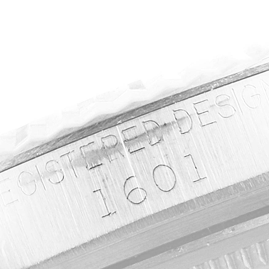 This close-up image shows the side engraving on a Rolex Vintage Collection 1601 Men
s Stainless Steel Silver Dial 1601 Men
s Stainless Steel Silver Dial model, highlighting the "1601" registered design mark.