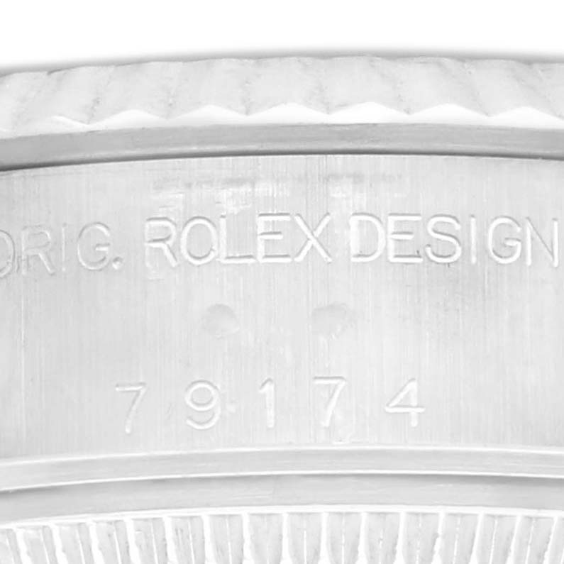 The image shows a close-up of the Rolex Datejust 79174 Women's Stainless Steel Silver Dial 79174 Women's Stainless Steel Silver Dial model's case side, highlighting the engraved model and serial number.