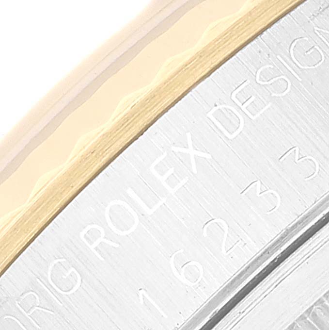 This close-up image shows the engraved side of the bezel on a Rolex Datejust 16233 Men's Steel and Gold (two tone) Grey Dial 16233 Men's Steel and Gold (two tone) Grey Dial watch.