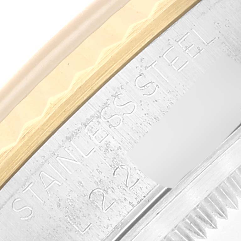 This close-up image shows the engraved stainless steel bezel section of a Rolex Datejust 16233 Men's Steel and Gold (two tone) Grey Dial 16233 Men's Steel and Gold (two tone) Grey Dial watch.