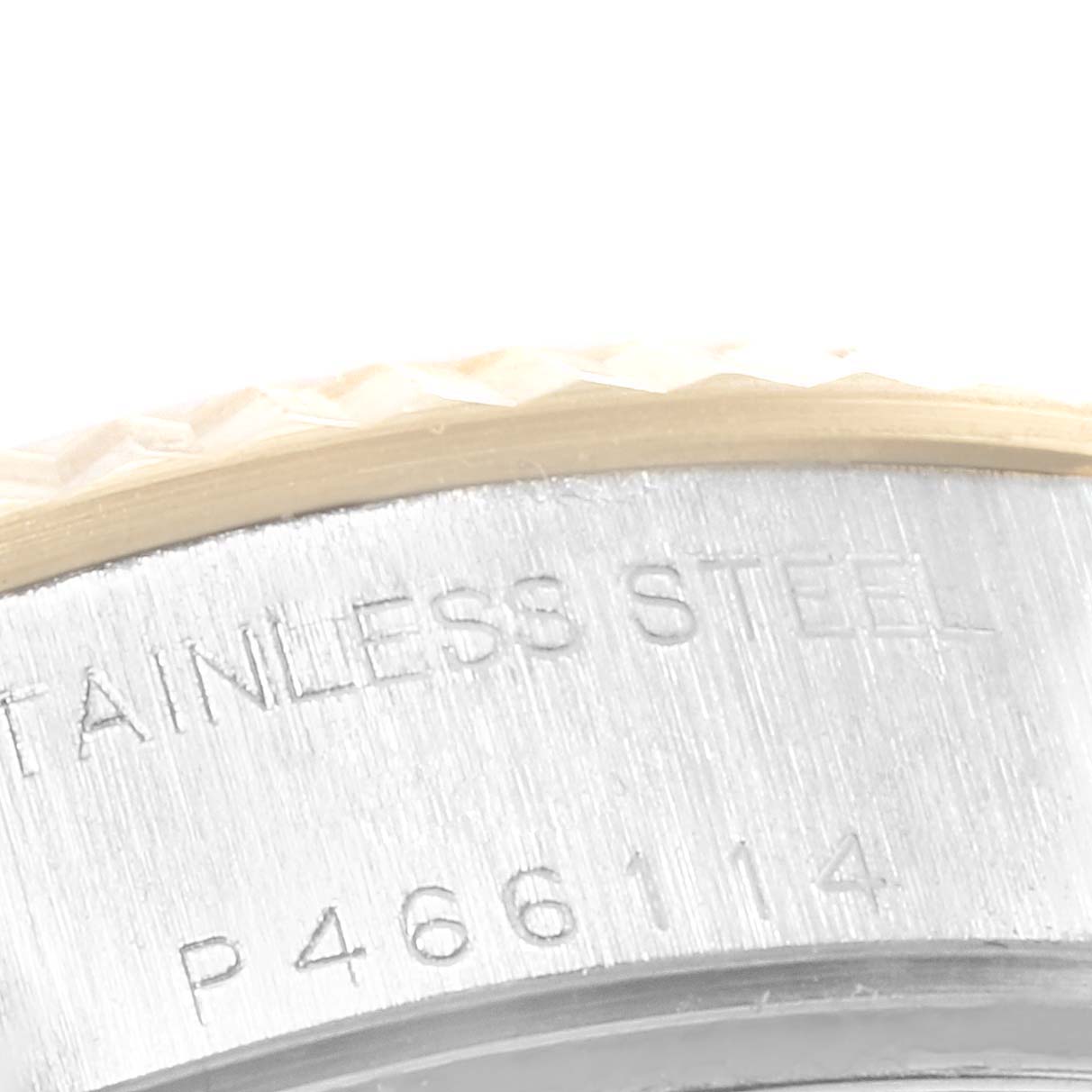 This image shows a close-up view of the side of a Rolex Datejust 79173 Women's Steel and Gold (two tone) White Dial 79173 Women's Steel and Gold (two tone) White Dial's case, focusing on the serial number and stainless steel engraving.