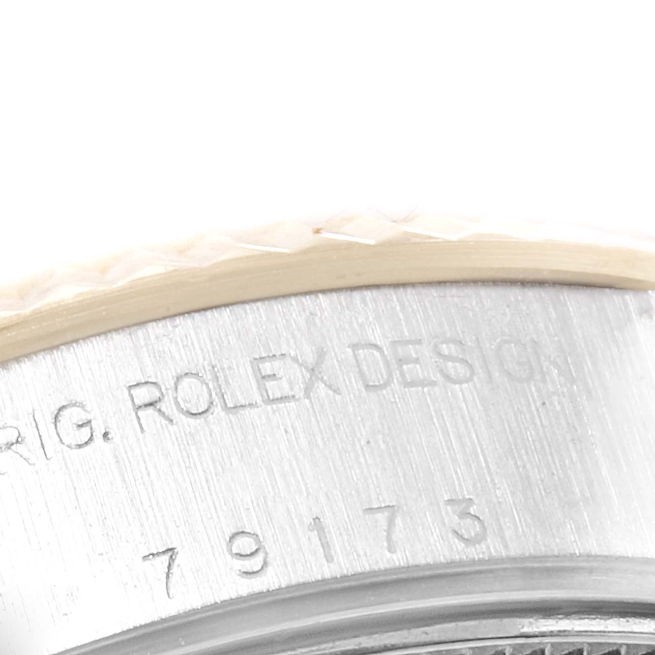 The image shows a close-up of the case side of a Rolex Datejust 79173 Women's Steel and Gold (two tone) White Dial 79173 Women's Steel and Gold (two tone) White Dial watch, featuring the "Rolex Design" engraving.
