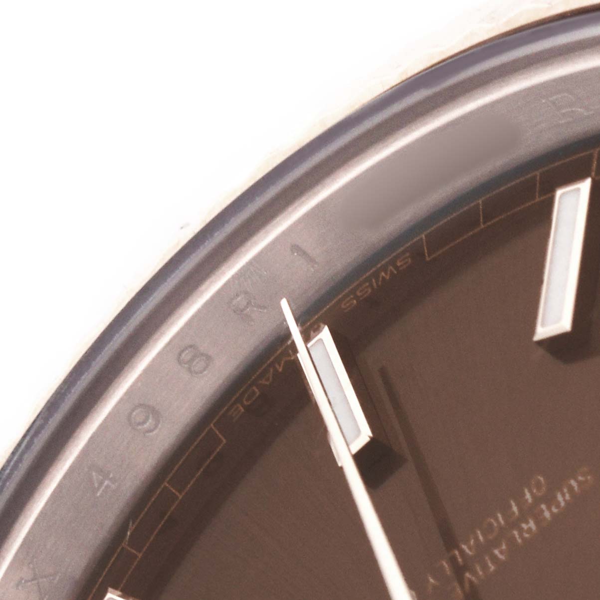 The image shows a close-up of the dial and hands of a Rolex President 228235 Men's Rose Gold Brown Dial model watch.