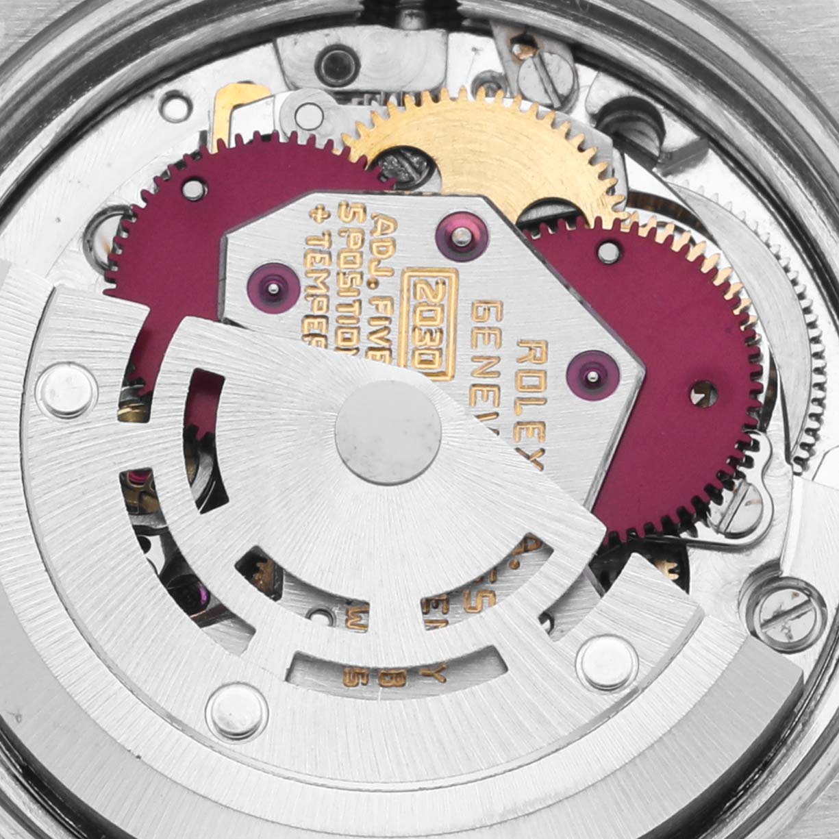 The image shows the intricate movement parts of a Rolex Oyster Perpetual 6723 Women's Stainless Steel Silver Dial 6723 Women's Stainless Steel Silver Dial watch, including gears and the rotor, from a top-down angle.