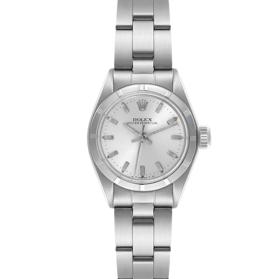 The Rolex Oyster Perpetual is shown from a top-down angle, displaying the full face, bracelet, and side crown.