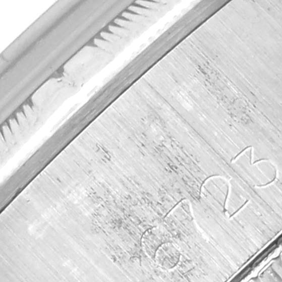 The image shows a close-up of the engraved text on the side of a Rolex Oyster Perpetual 6723 Women's Stainless Steel Silver Dial 6723 Women's Stainless Steel Silver Dial watch case.