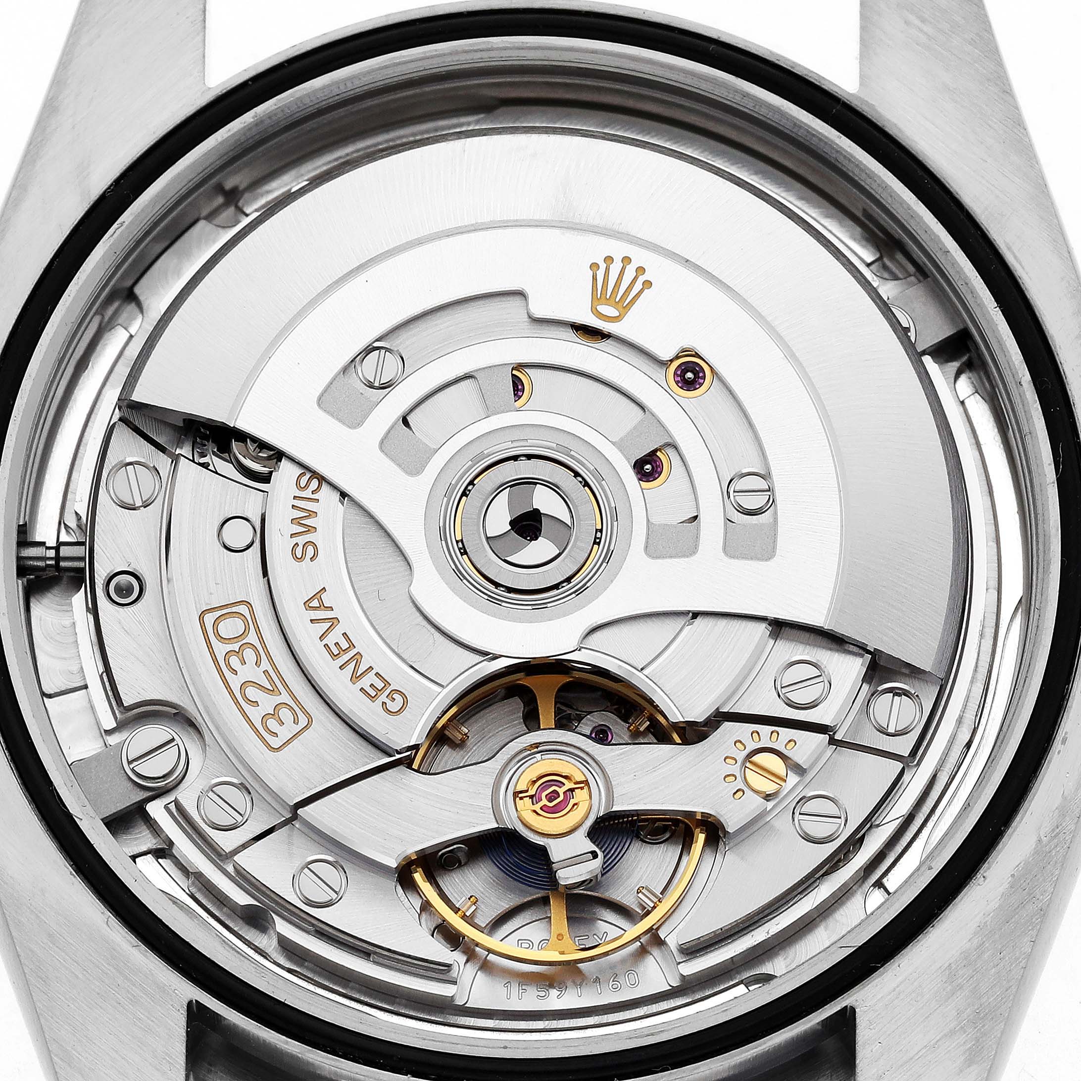 The image shows the movement of a Rolex Oyster Perpetual 124300 Men's Stainless Steel Silver Dial watch, focusing on its intricate mechanical parts.