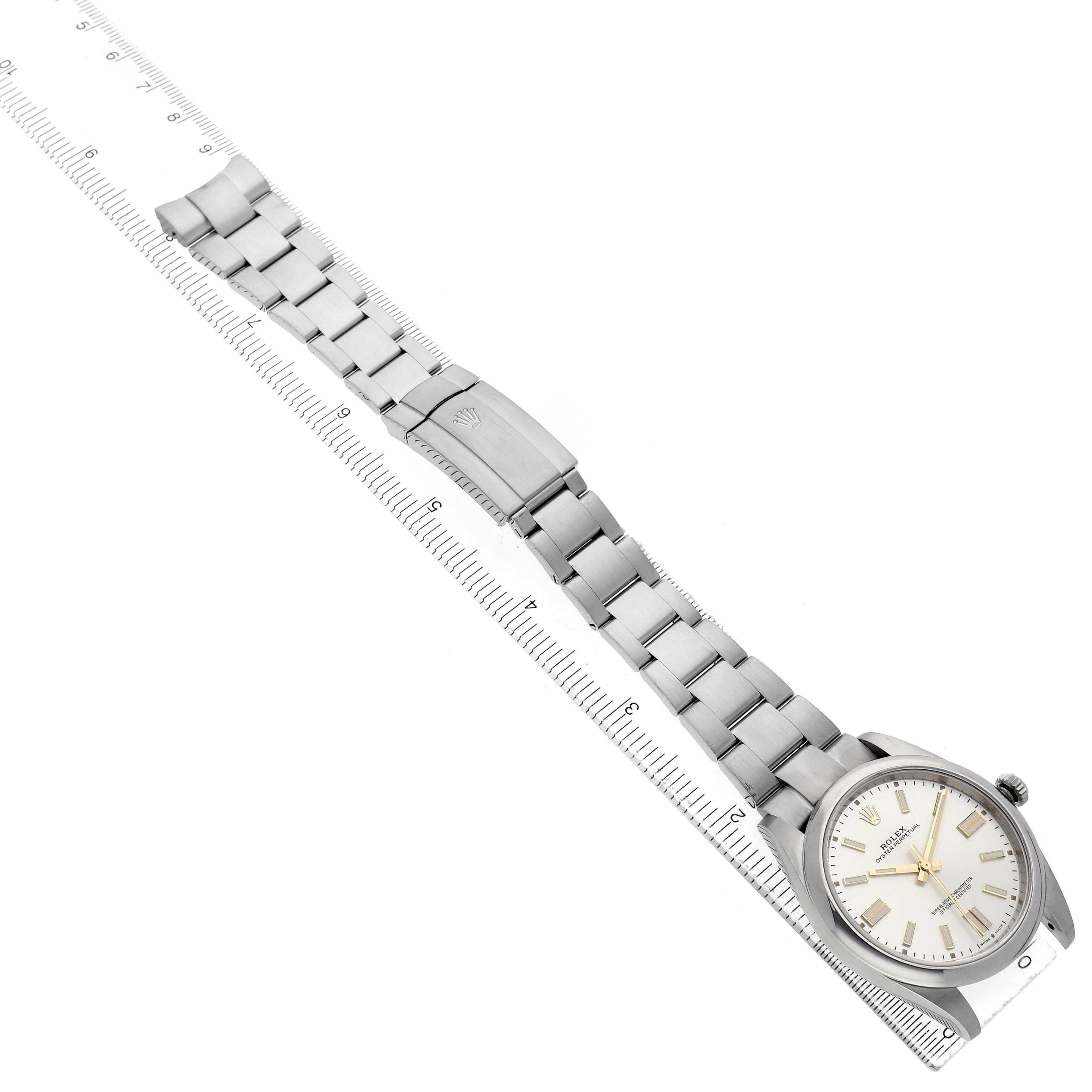 The Rolex Oyster Perpetual 124300 Men's Stainless Steel Silver Dial watch is shown at a diagonal angle, highlighting the face, bezel, bracelet, and clasp.