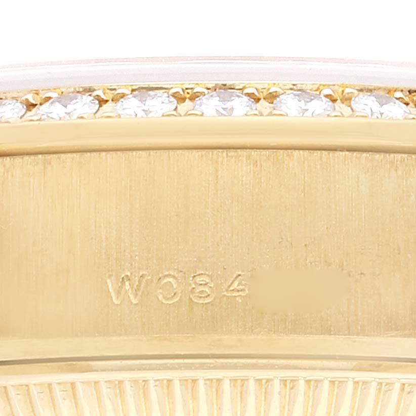 This close-up image of the Rolex President 79268 Women
s Yellow Gold Champagne Dial 79268 Women
s Yellow Gold Champagne Dial model watch shows the edge of the bezel adorned with diamonds and part of the case.