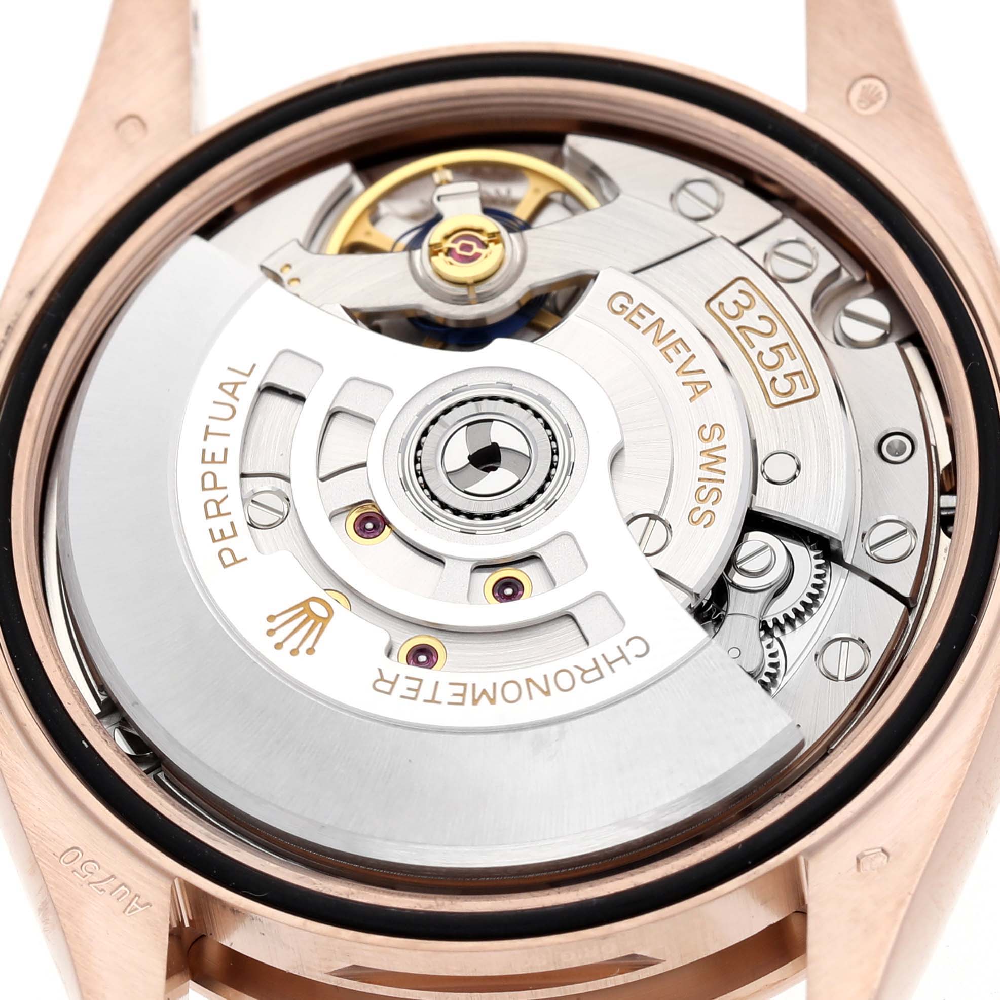 The image shows the movement of a Rolex President 128235 Men's Rose Gold Grey Dial watch from the back, highlighting the rotor, gears, and other internal components.