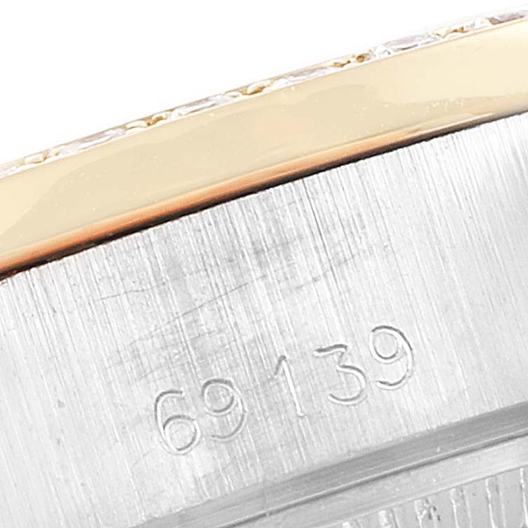 This image shows a close-up of the serial number engraving and part of the bezel of a Rolex President 69139 Women's White Gold Brown Dial 69139 Women's White Gold Brown Dial model watch.