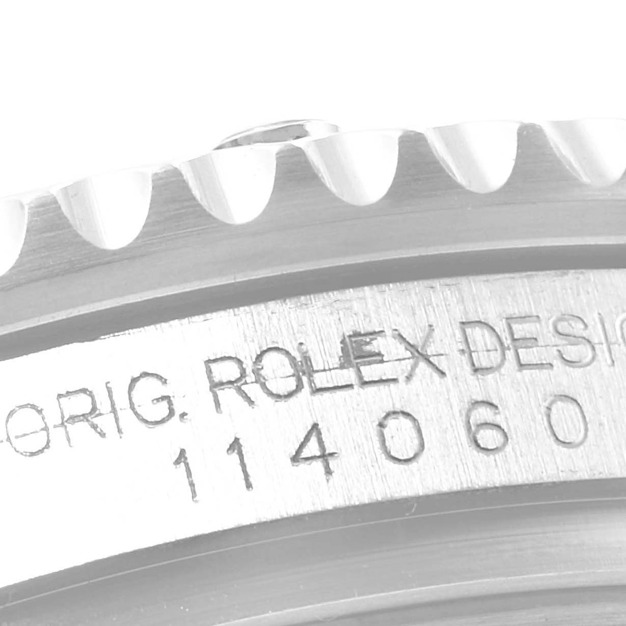 This image shows a close-up of the engraved case and the edge of the bezel of a Rolex Submariner 114060 Men
s Stainless Steel Black Dial 114060 Men
s Stainless Steel Black Dial watch.